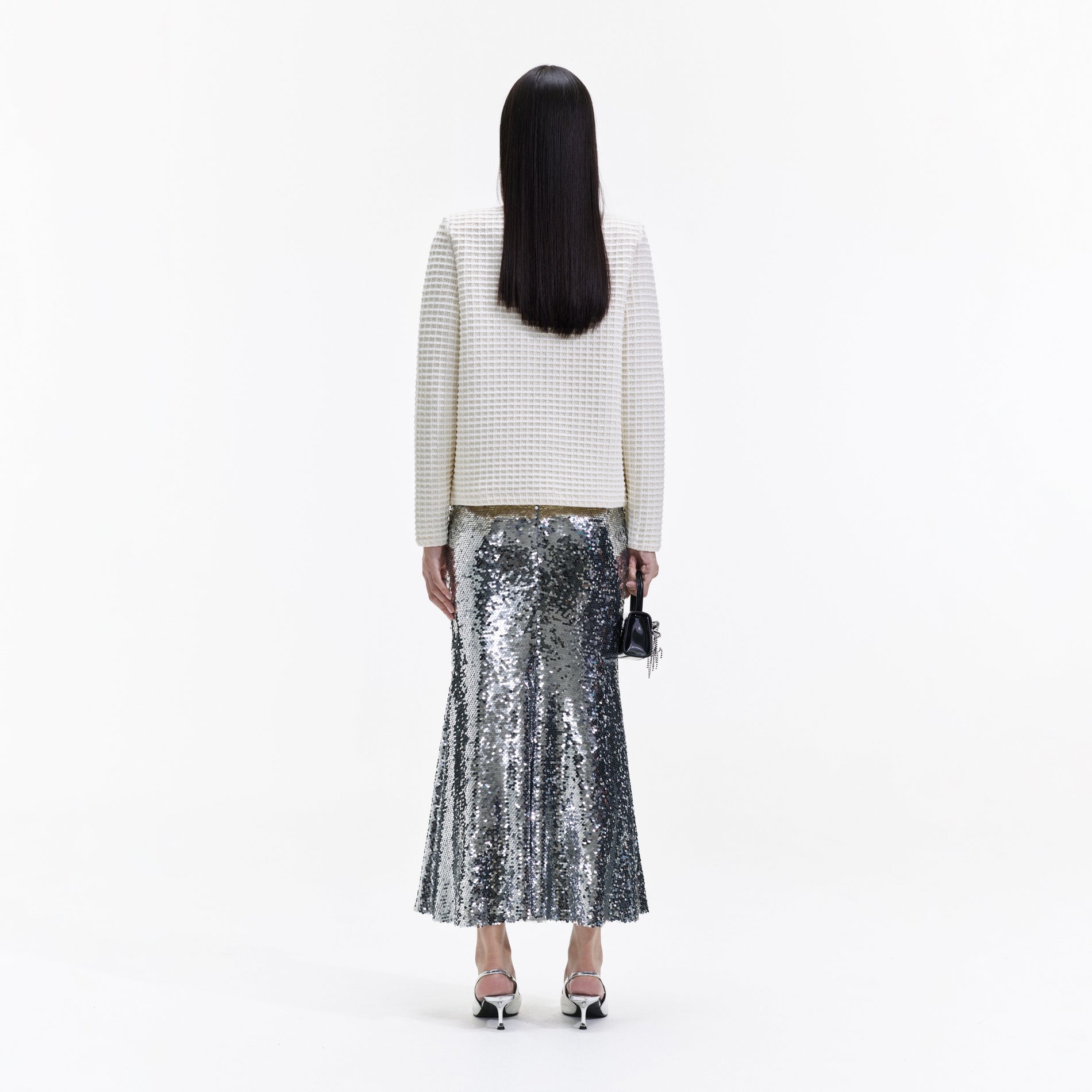 Back view of a woman wearing the Cream Knit Cardigan