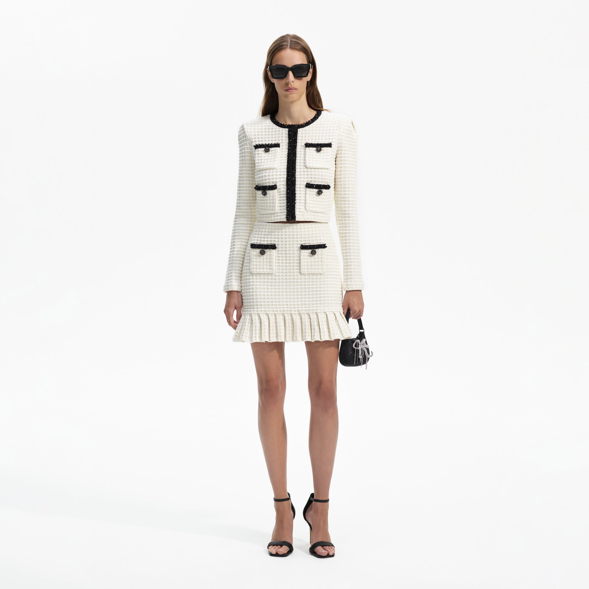 Front view of a woman wearing the Cream Textured Knit Mini Skirt