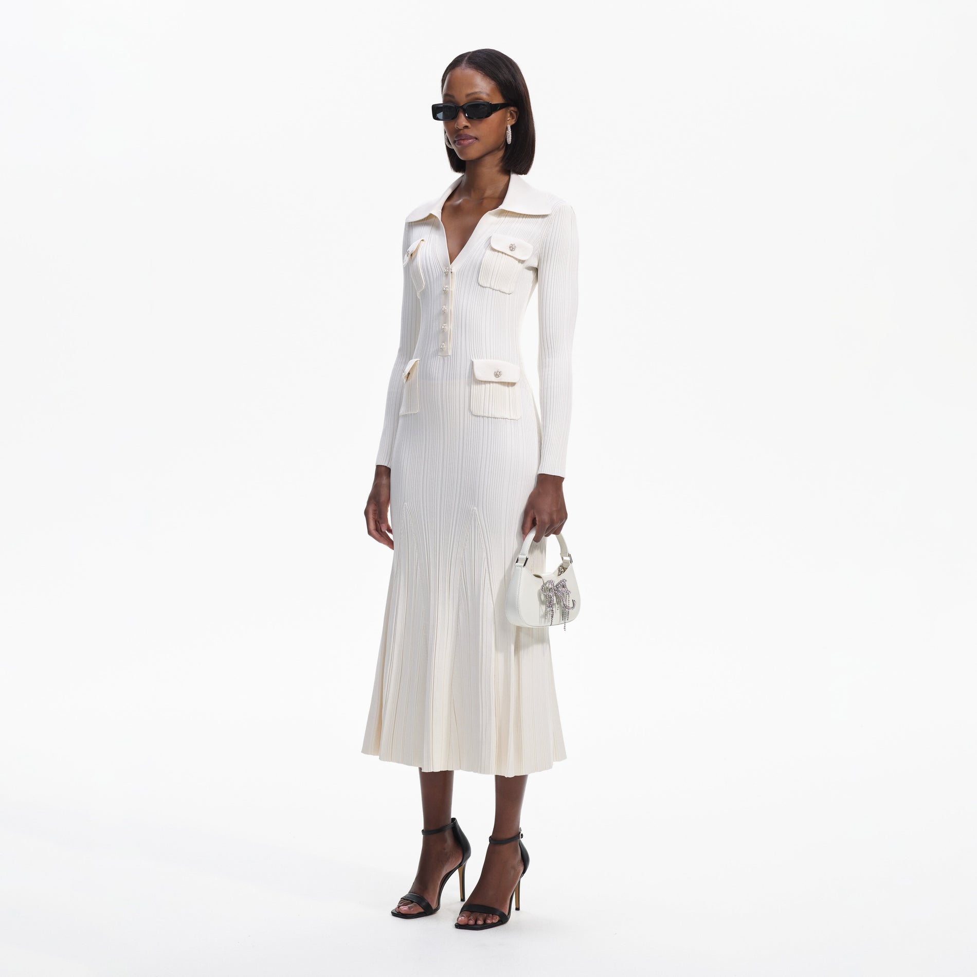Side view of a woman wearing the Cream Knit Midi Dress