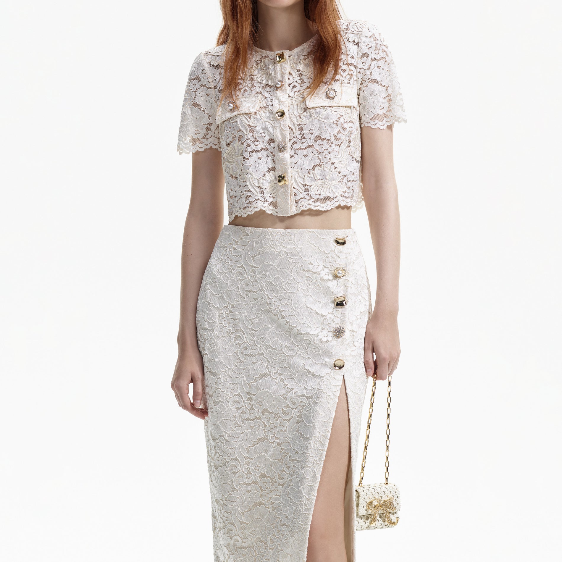 A close up of a woman wearing the Cream Cord Lace Split Midi Skirt