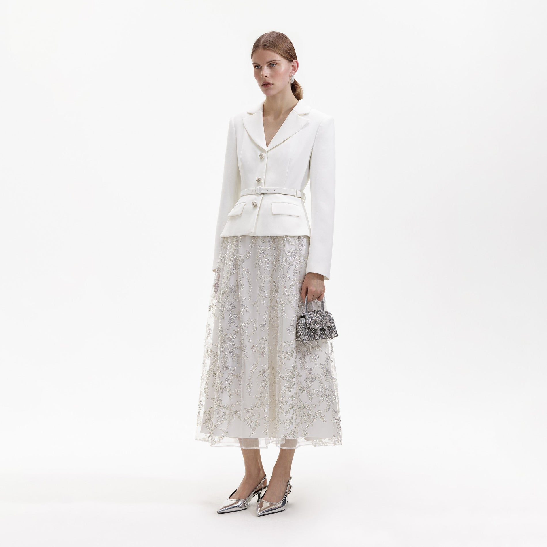 Side view of a woman wearing the White Crepe Embellished Midi Dress