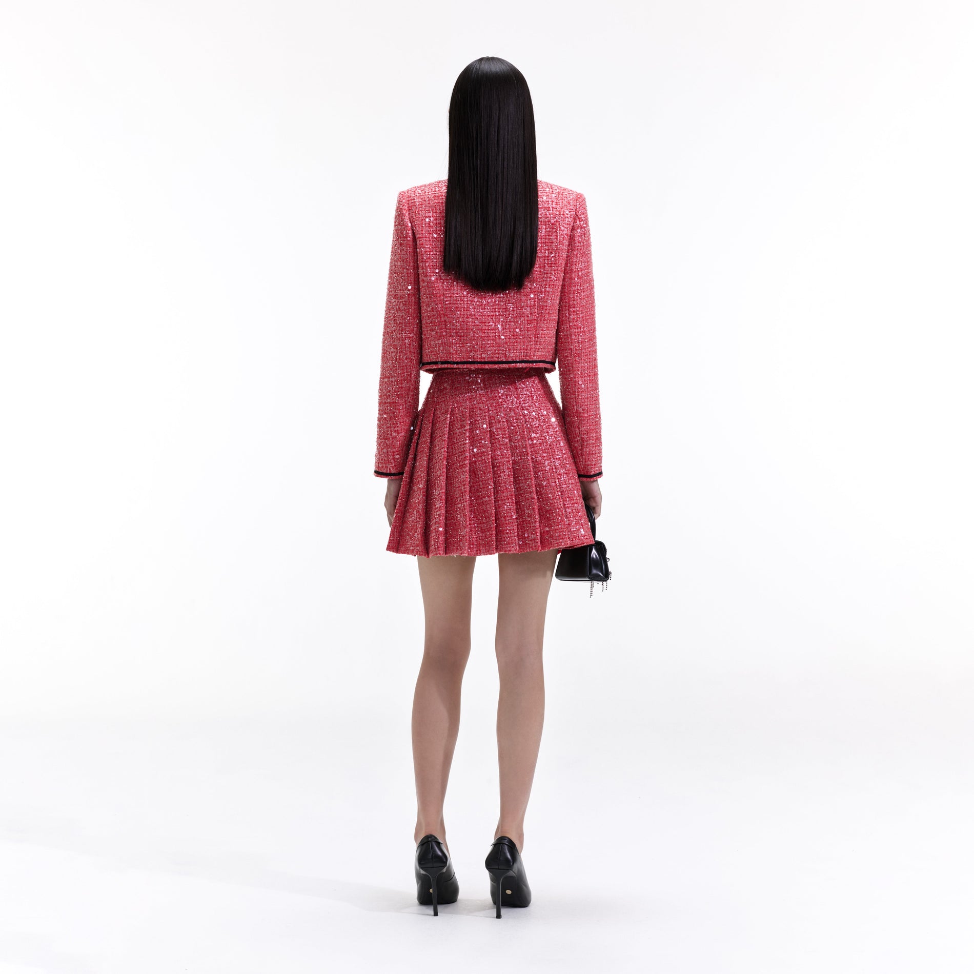 Back view of a woman wearing the Red Boucle Mini Skirt