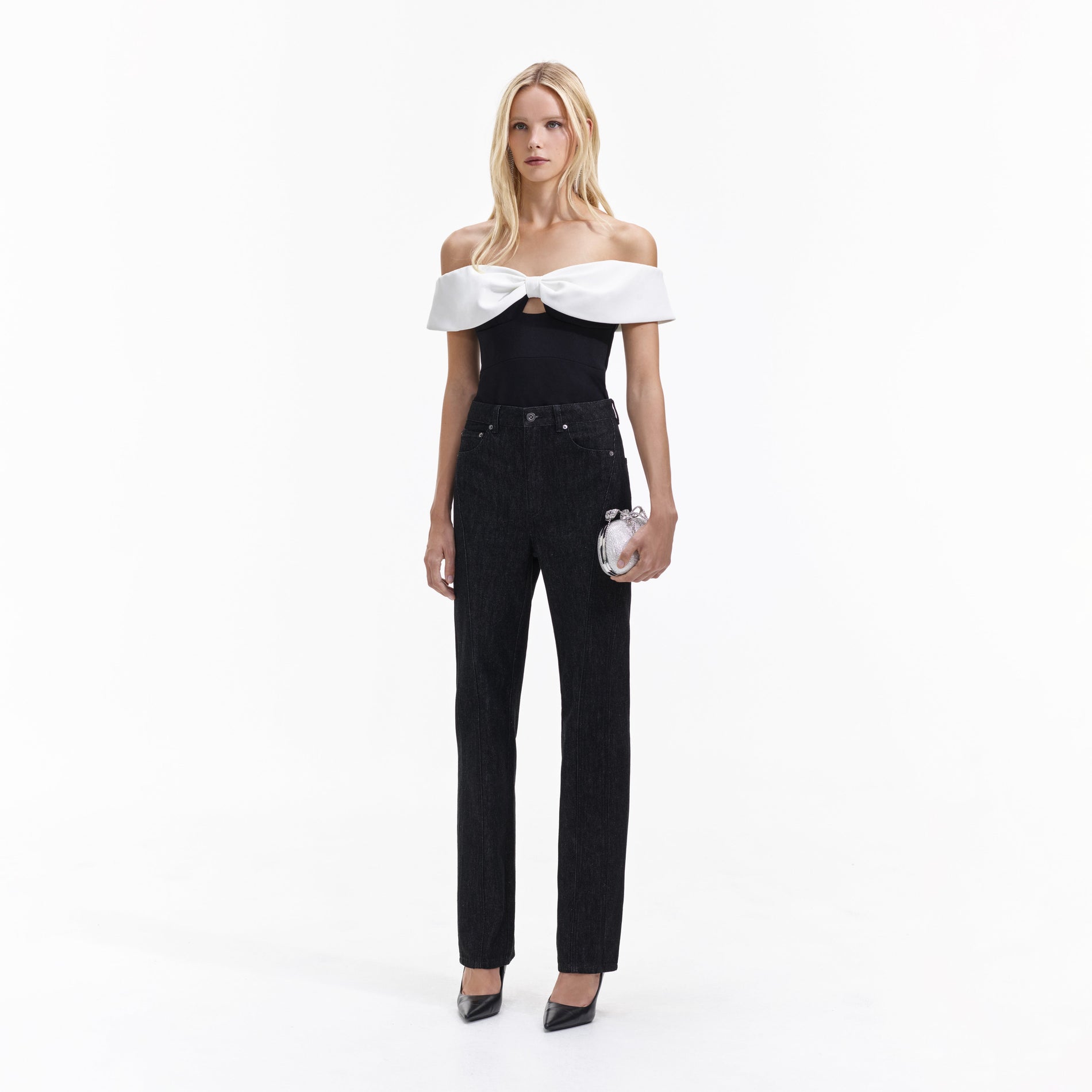 Side view of a woman wearing the Black Crepe Bow Top