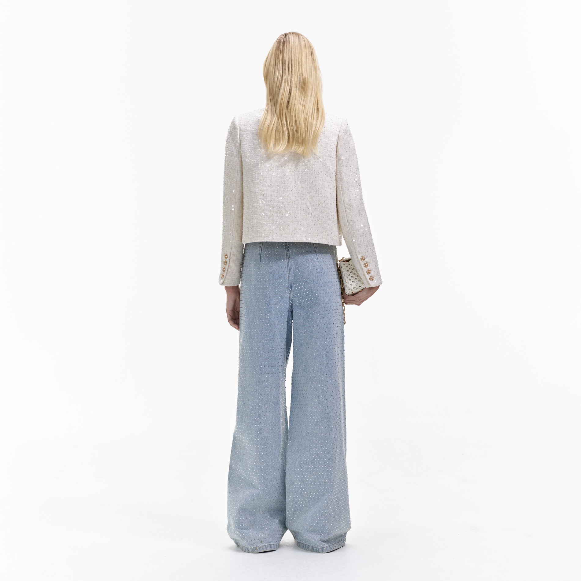 Back view of a woman wearing the Cream Sequin Boucle Jacket