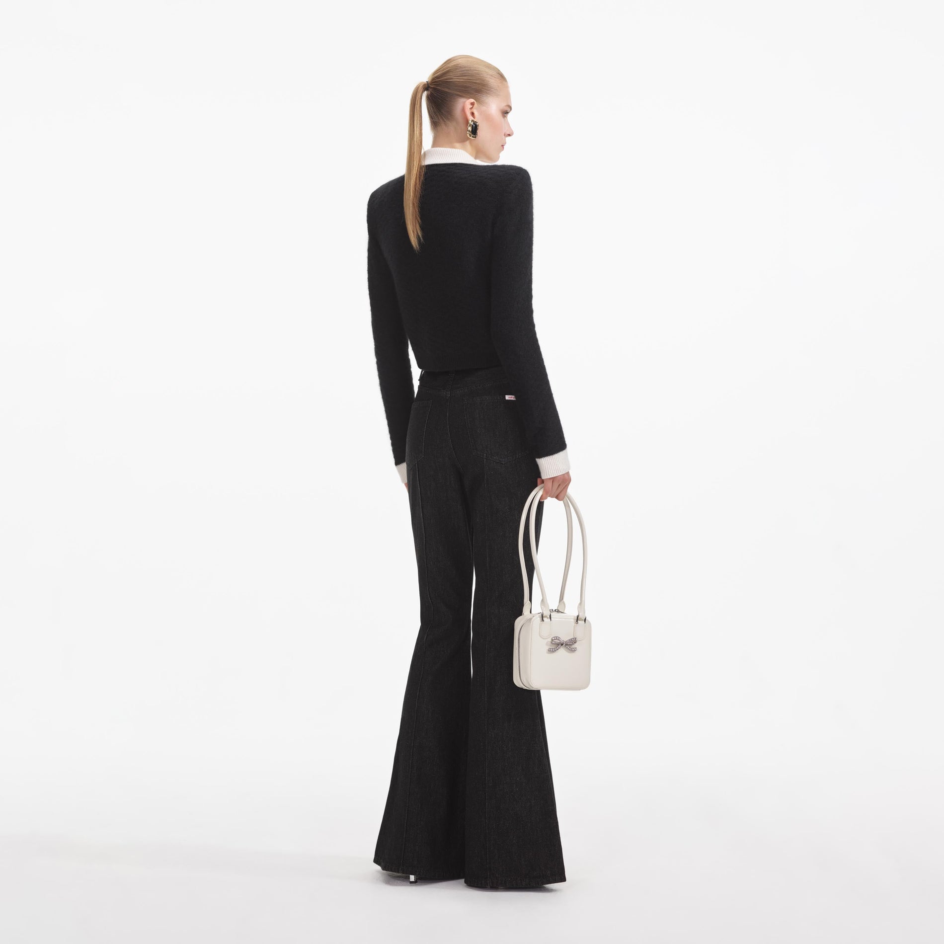 Back view of a woman wearing the Black Textured Cardigan