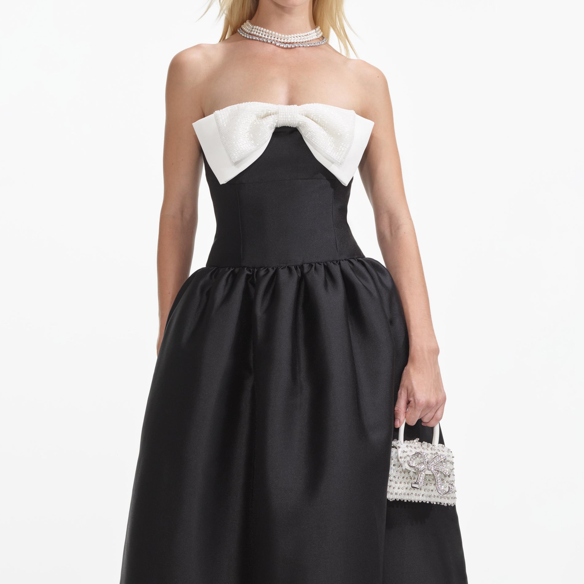 A close up of a woman wearing the Black Taffeta Contrast Bow Midi Dress