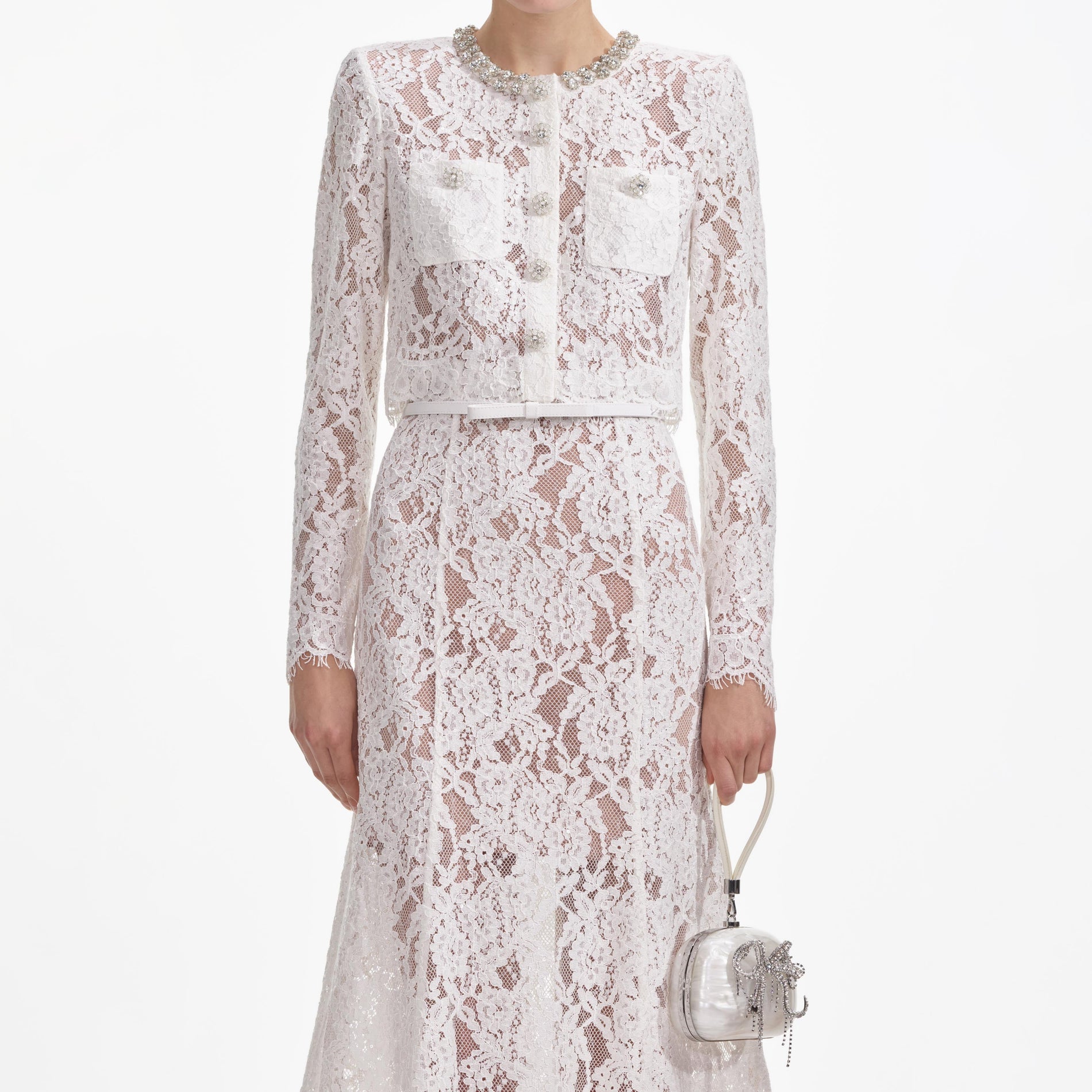 A close up of a woman wearing the White Lace Embellished Midi Dress