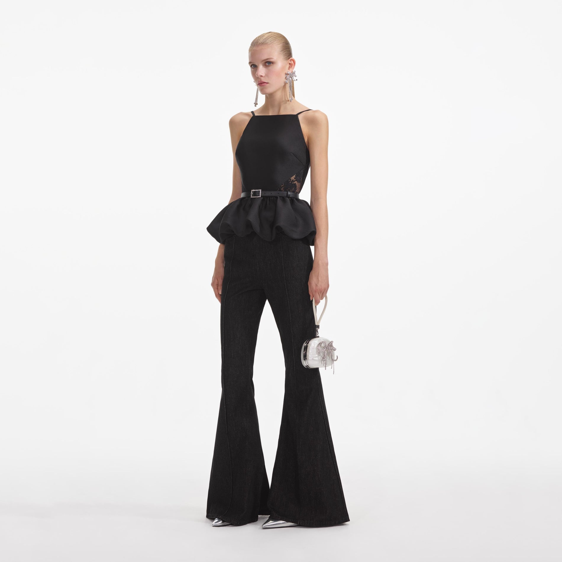 Side view of a woman wearing the Black Taffeta Peplum Top