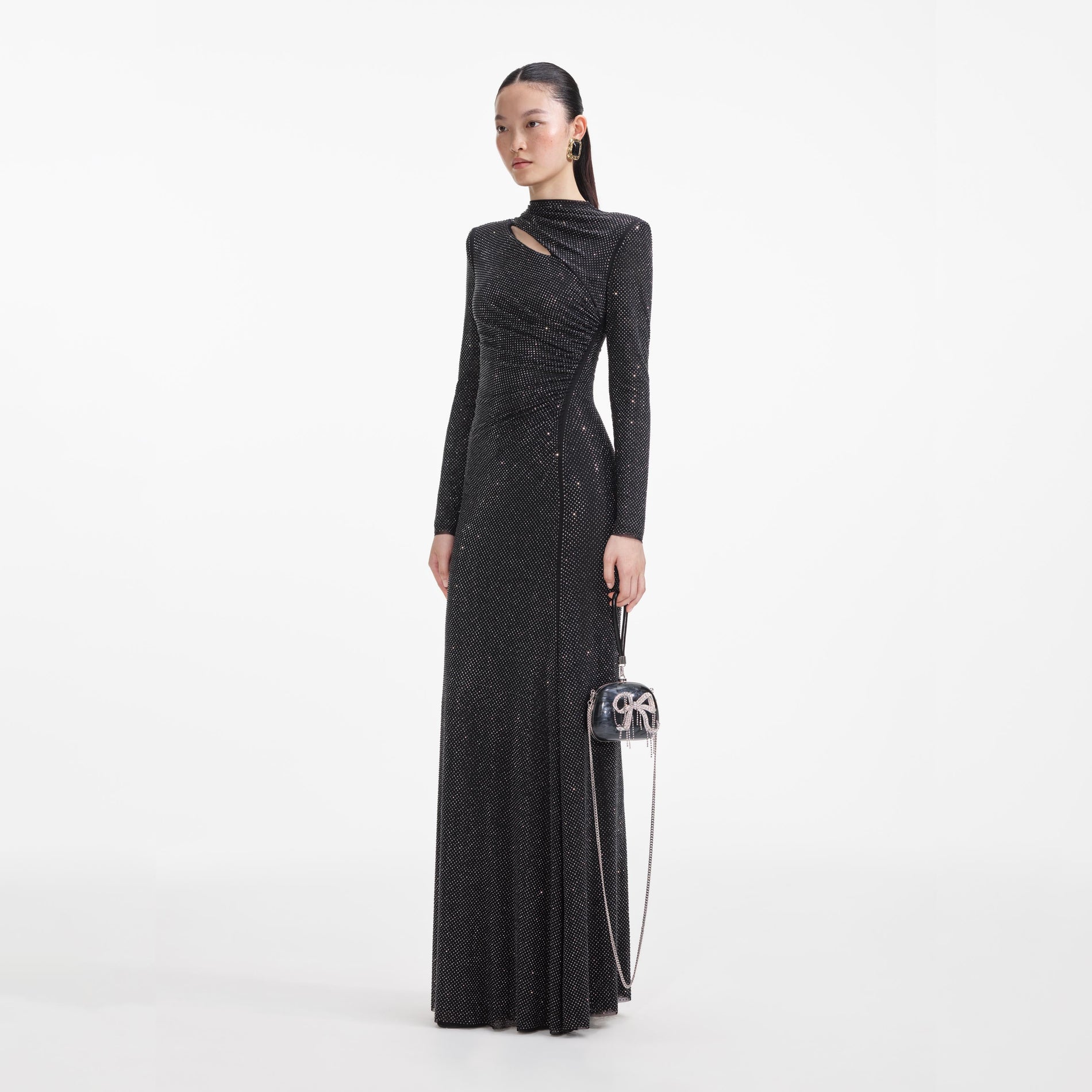 Side view of a woman wearing the Black Rhinestone Mesh Cut Out Maxi Dress