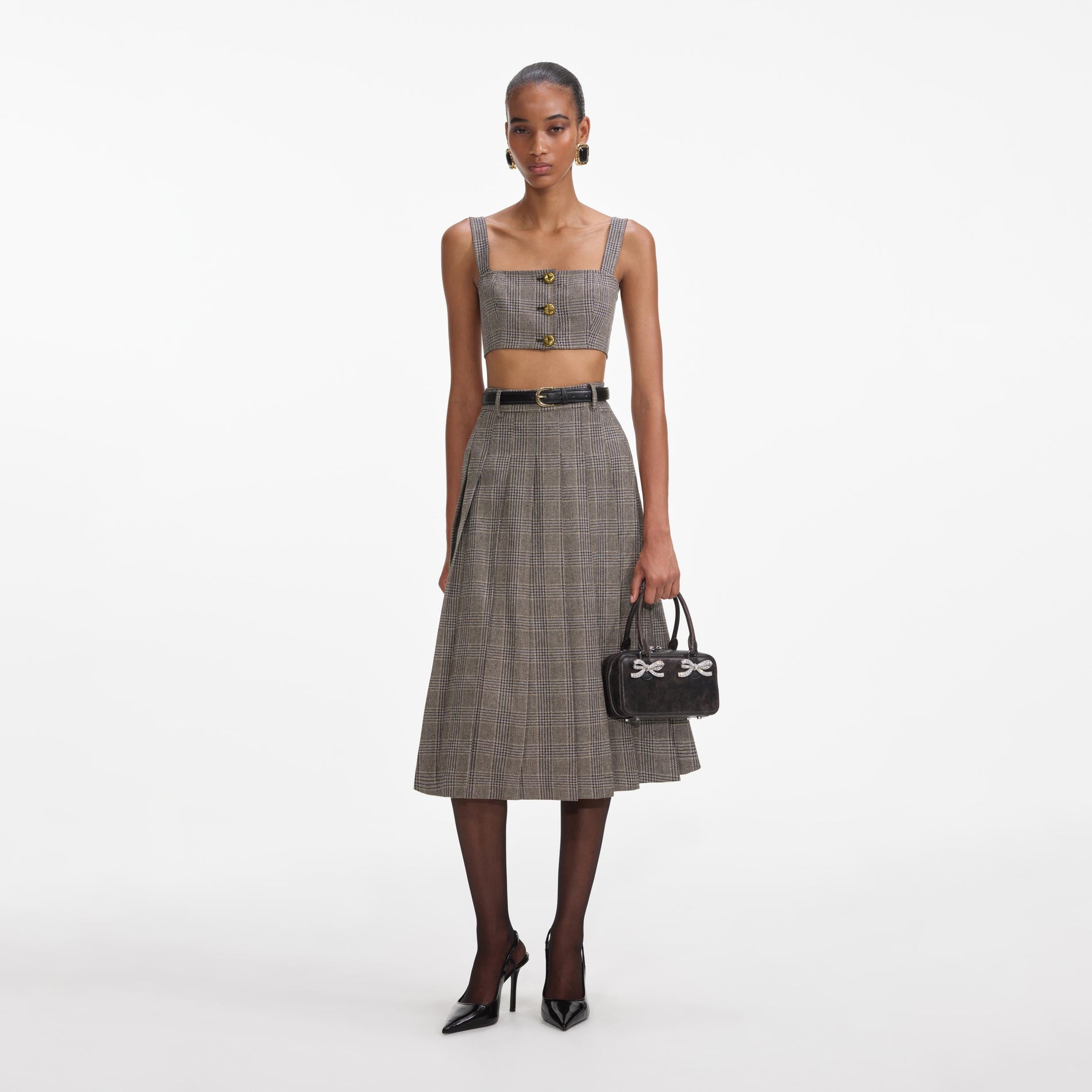 Front view of a woman wearing the Brown Check Pleated Midi Skirt