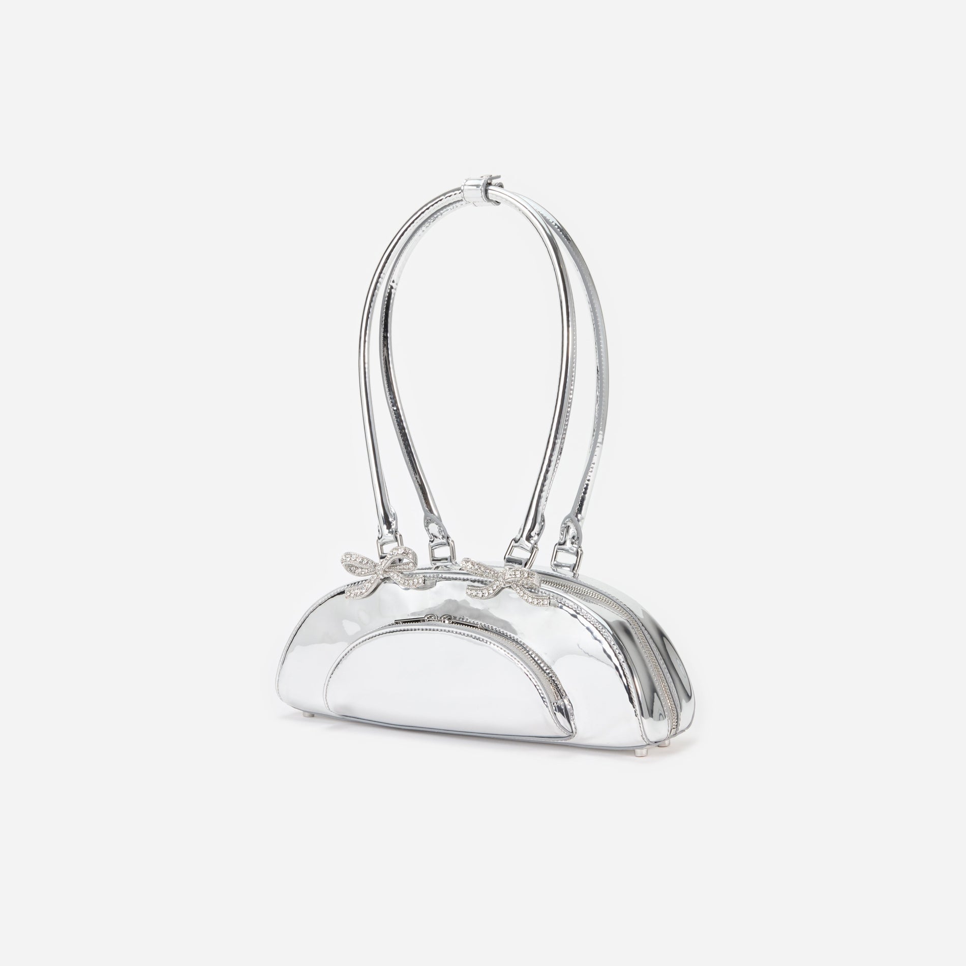 Side view of a woman wearing the Silver Metallic Curved Shoulder Bag
