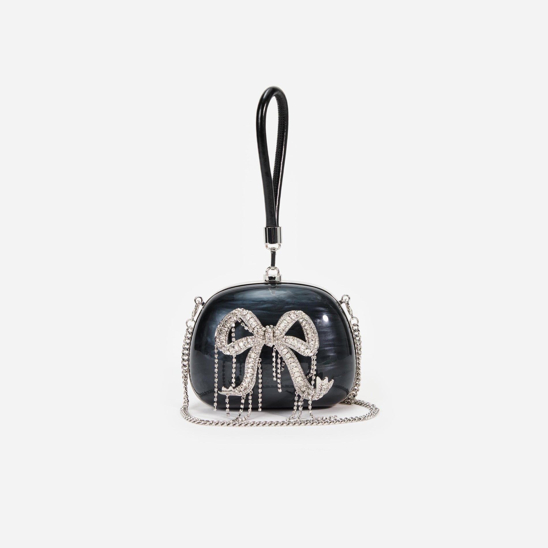 A close up of a woman wearing the Black Pearl Top Handle Clutch Bag