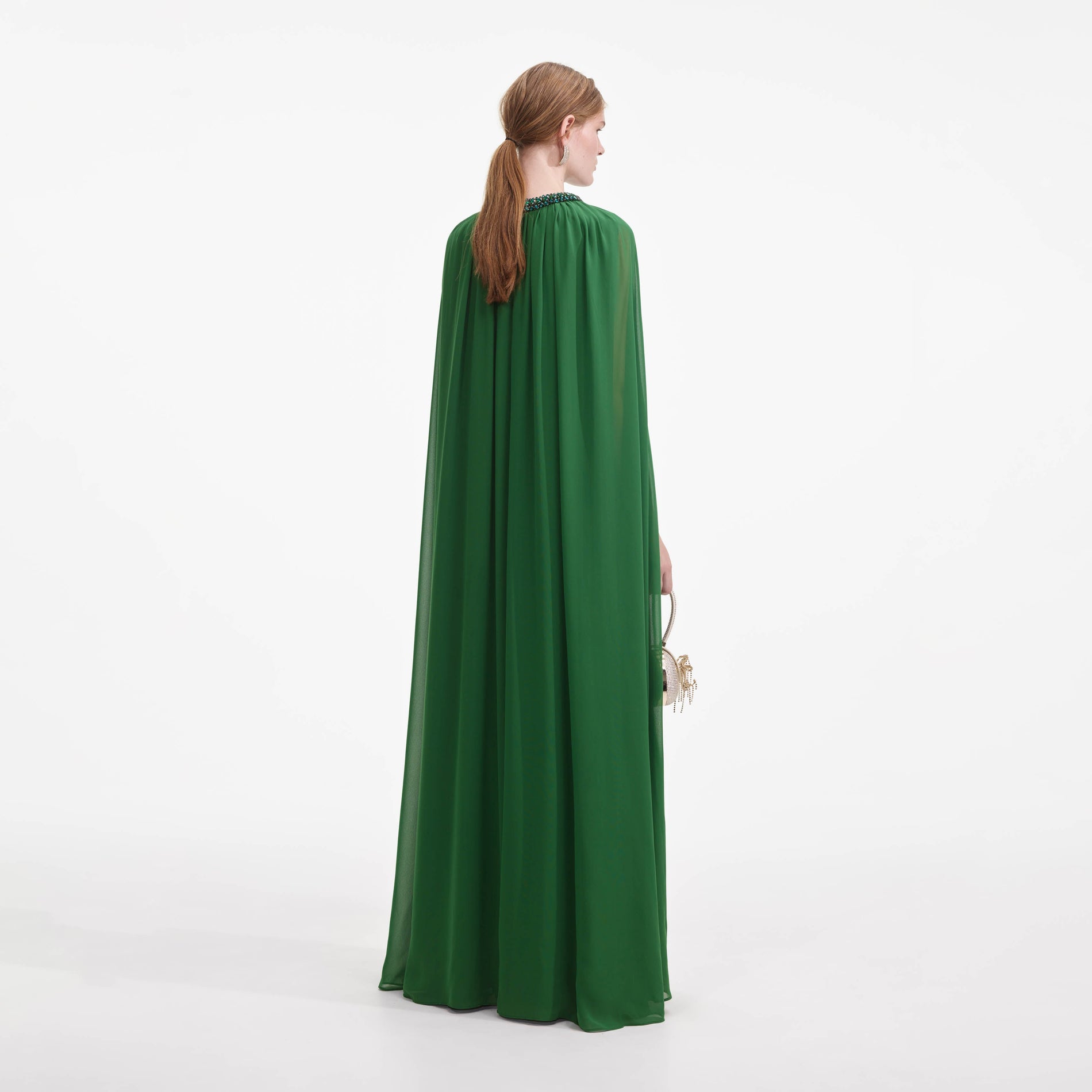 Back view of a woman wearing the Green Chiffon Cape Maxi Dress