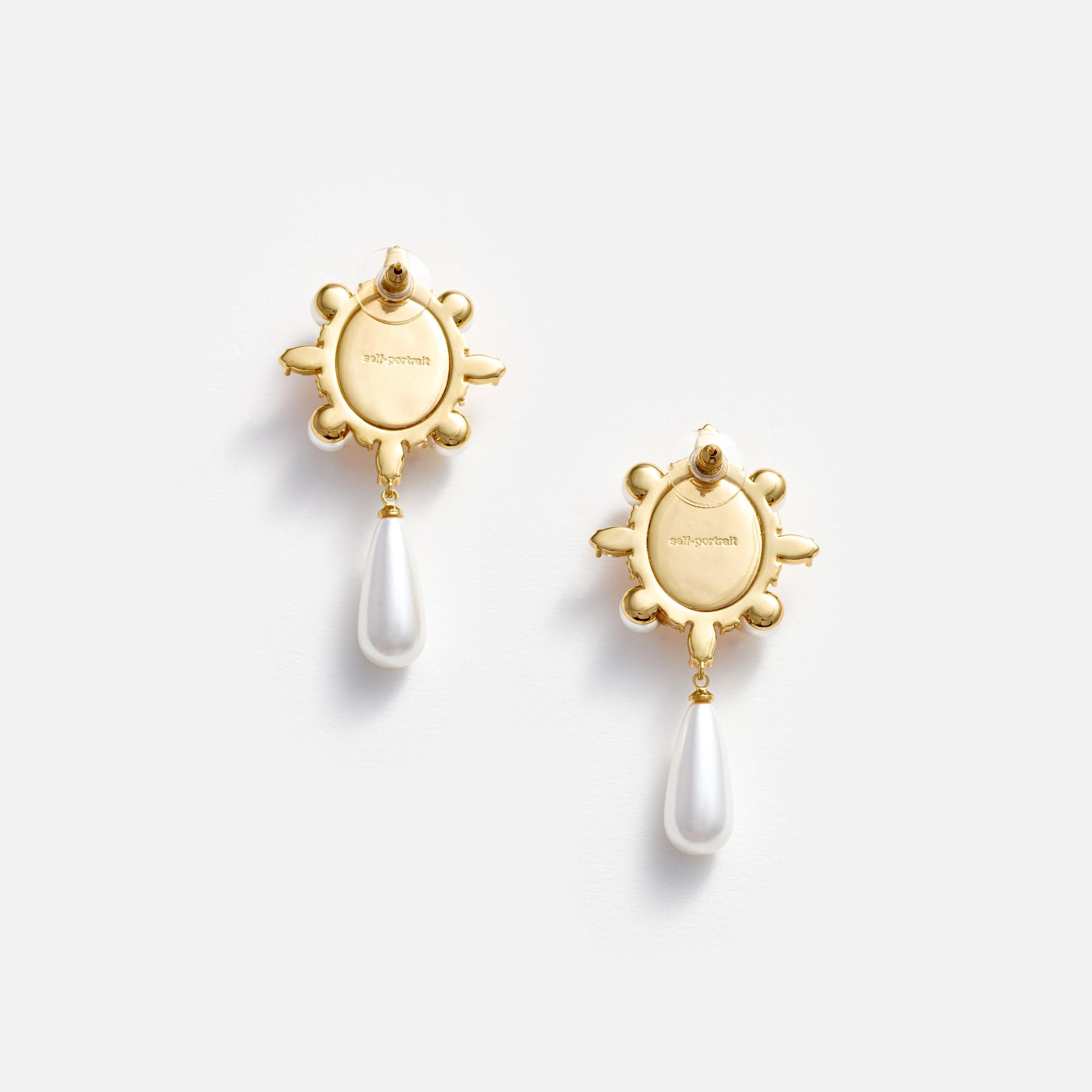 Side view of a woman wearing the Gold Pearl Droplet Earrings