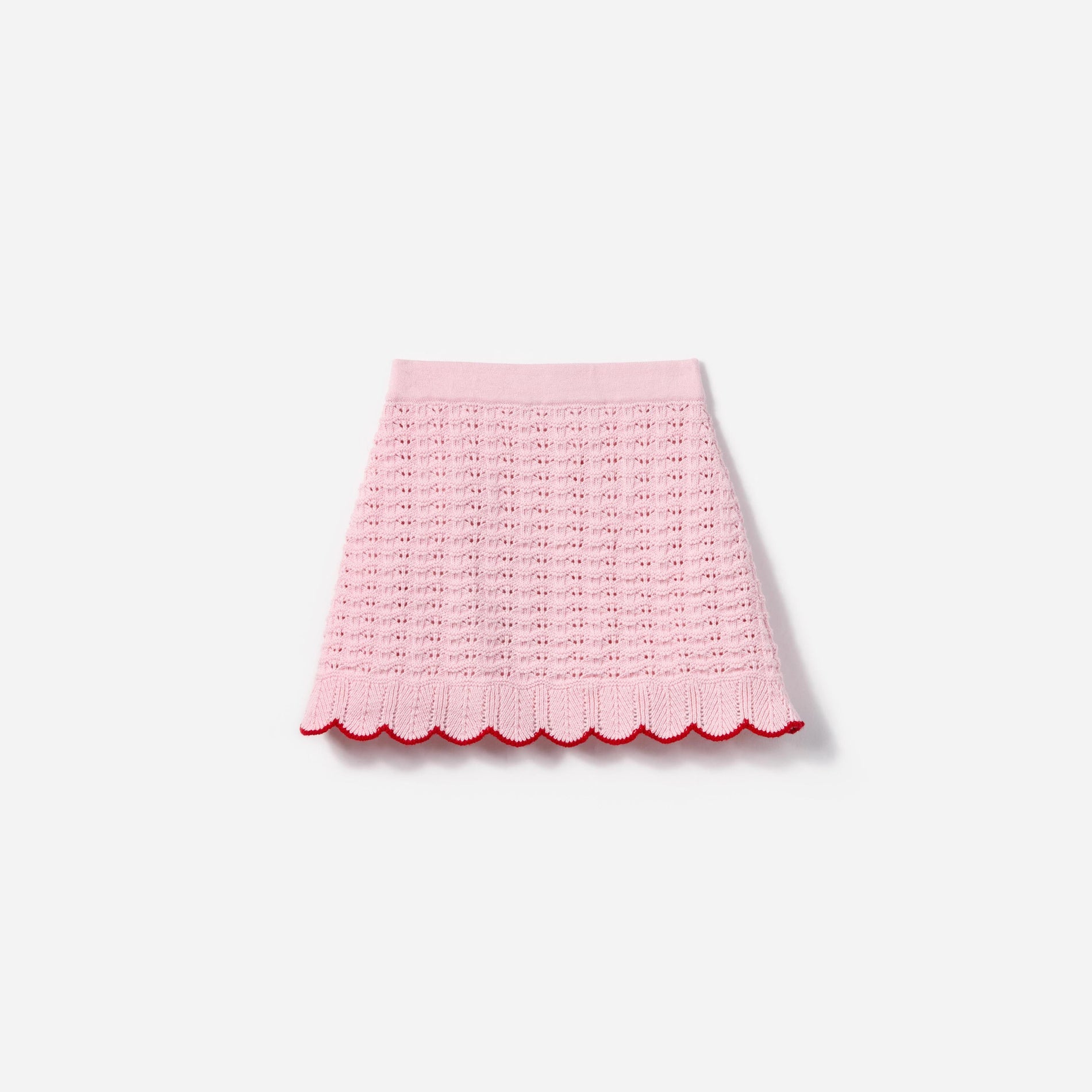 Side view of a woman wearing the Pink Textured Knit Heart Detail Skirt