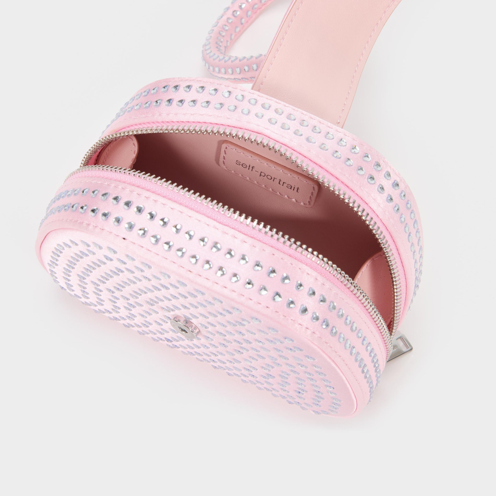 A close up of a woman wearing the Pink Heart Rhinestone Bag