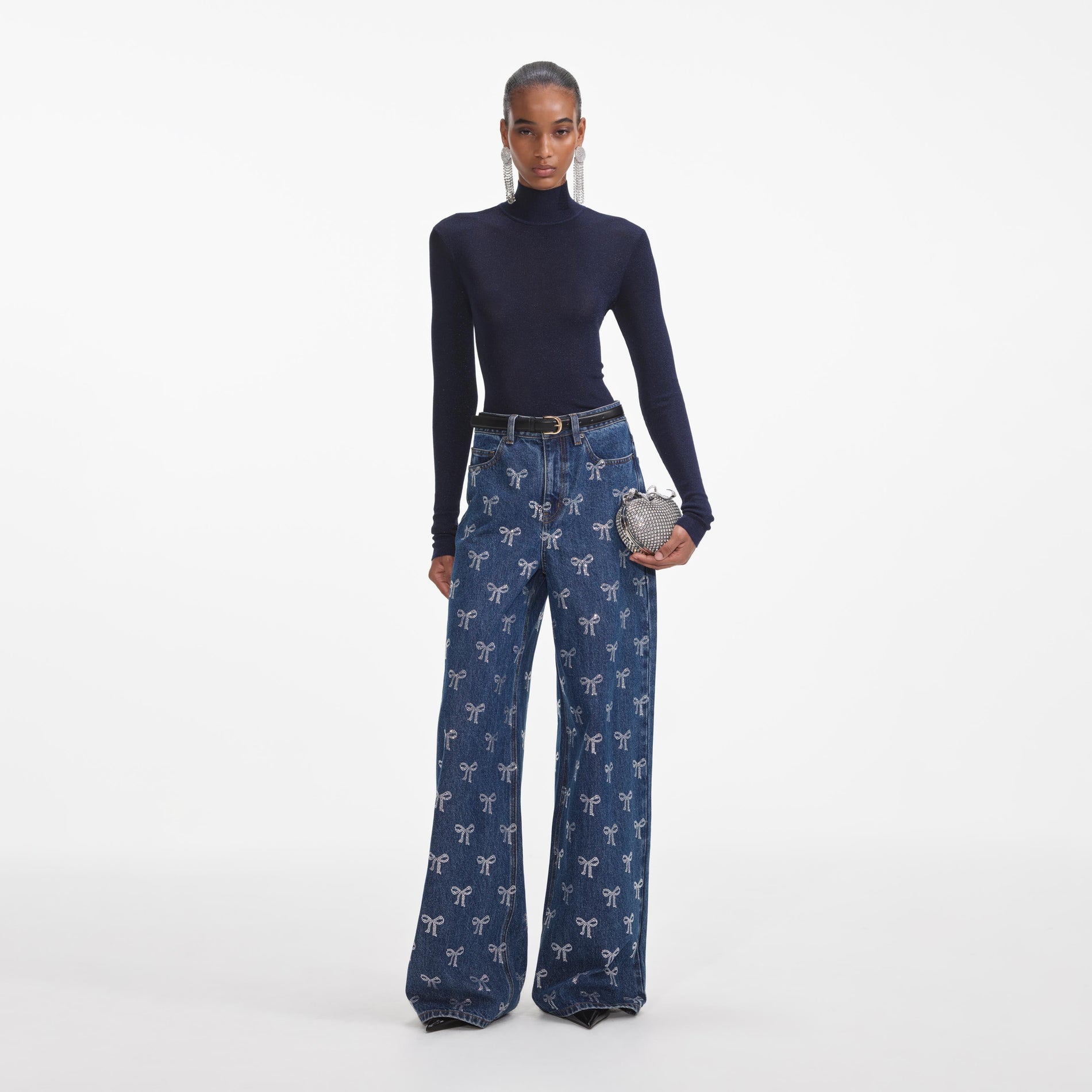 Front view of a woman wearing the Rhinestone Bow Denim Jeans