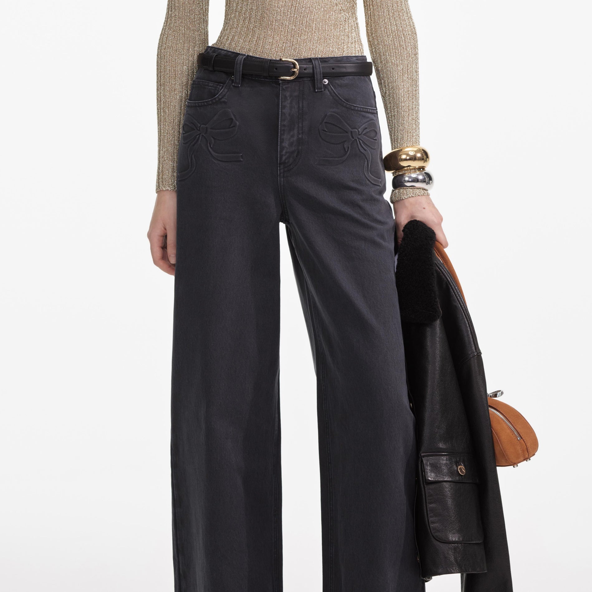 A close up of a woman wearing the Grey Denim Bow Motif Jeans