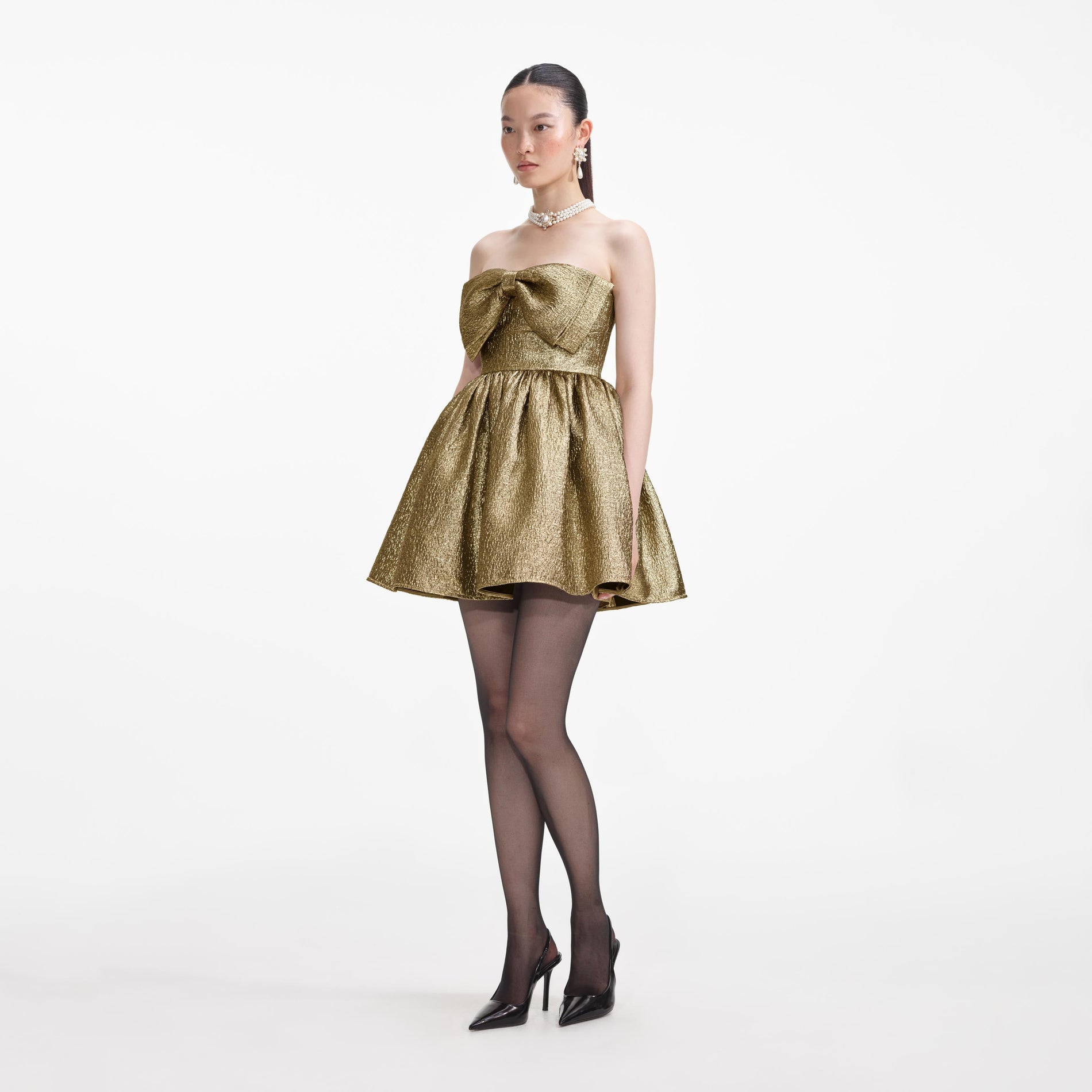 Side view of a woman wearing the Gold Metallic Jacquard Mini Dress