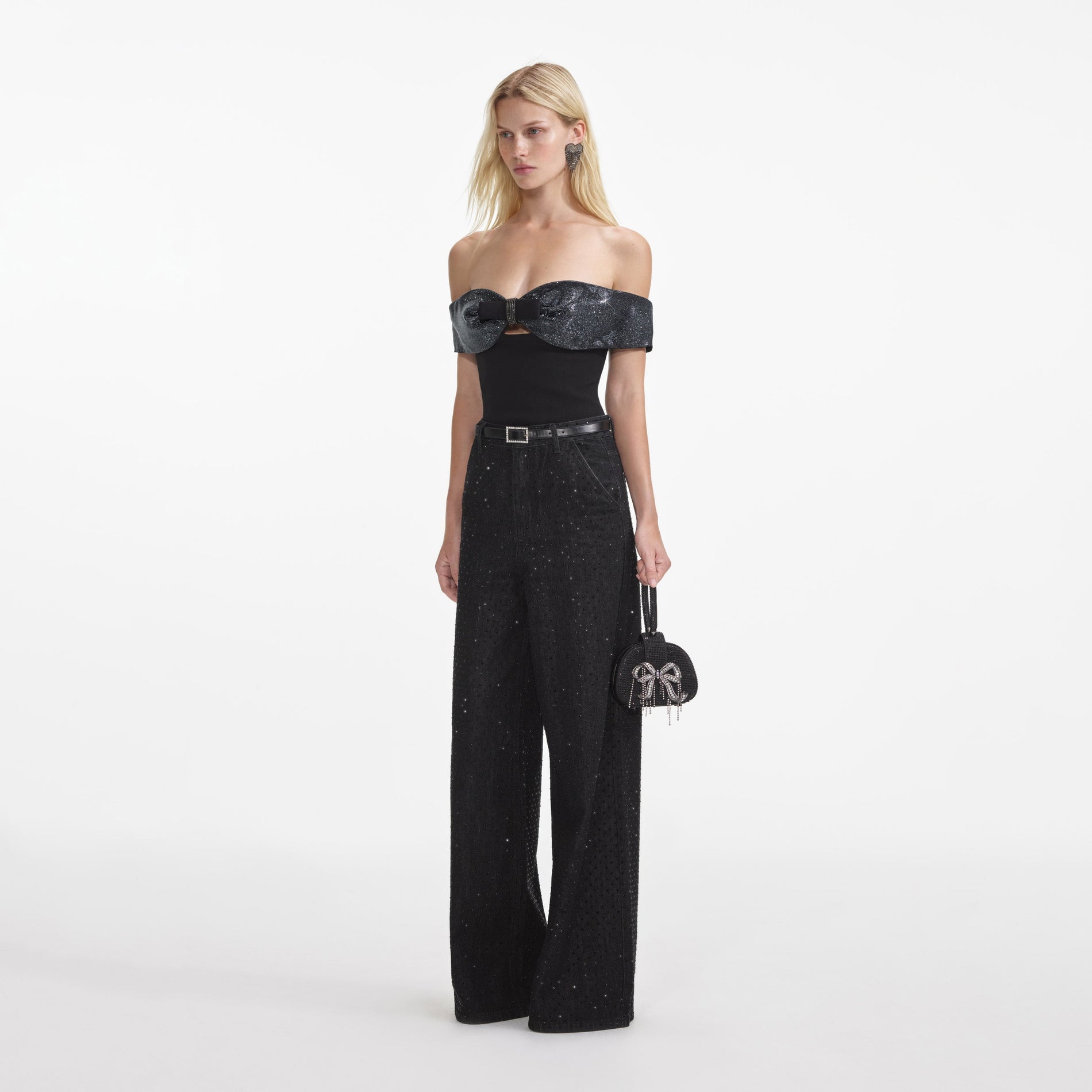 Side view of a woman wearing the Black Crepe Bow Top