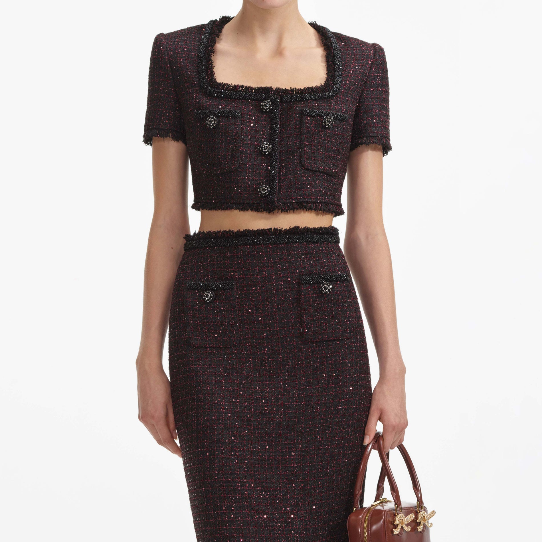 A close up of a woman wearing the Black Metallic Boucle Top