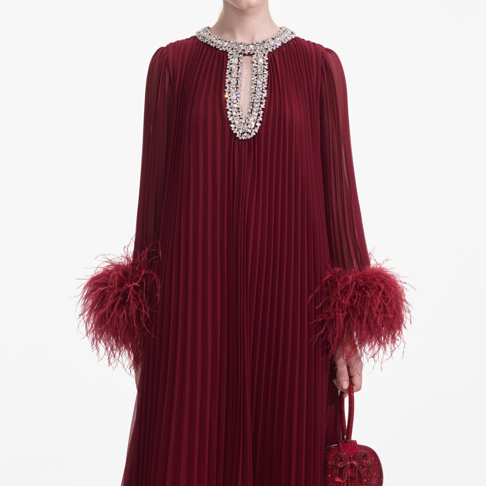 A close up of a woman wearing the Burgundy Chiffon Feather Midi Dress