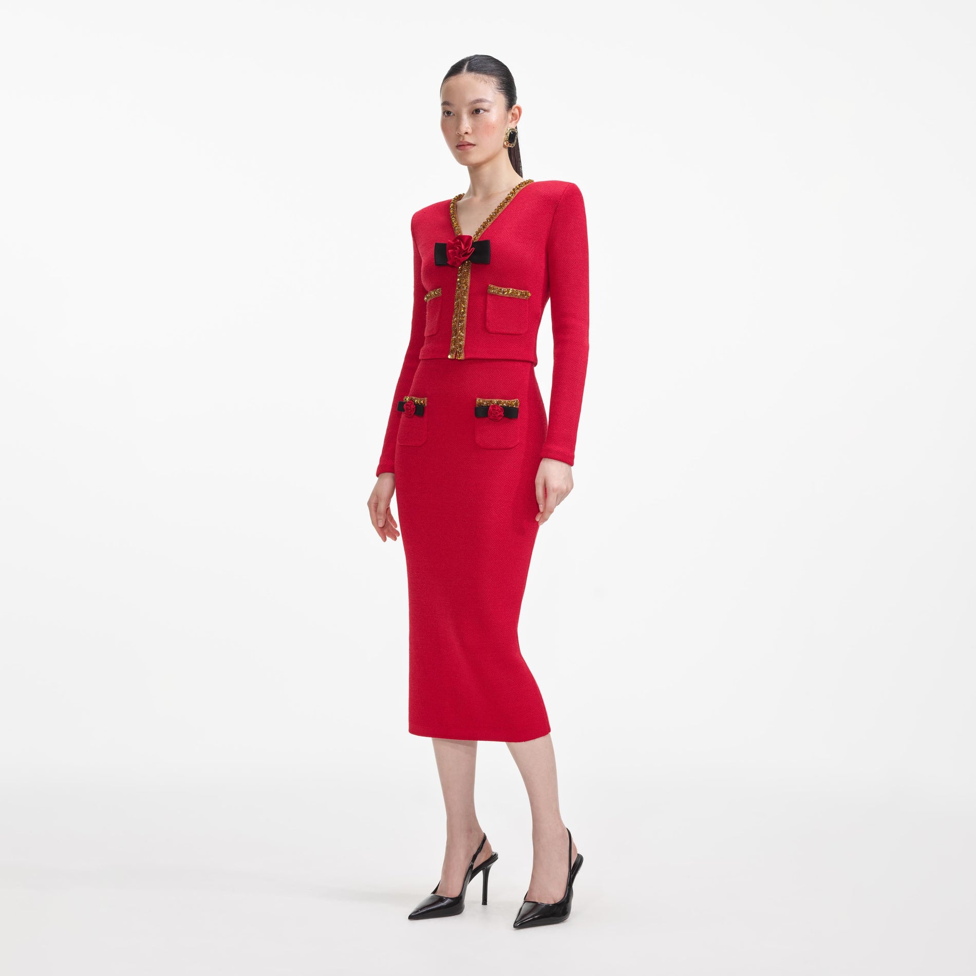 Side view of a woman wearing the Red Textured Knit Corsage Cardigan
