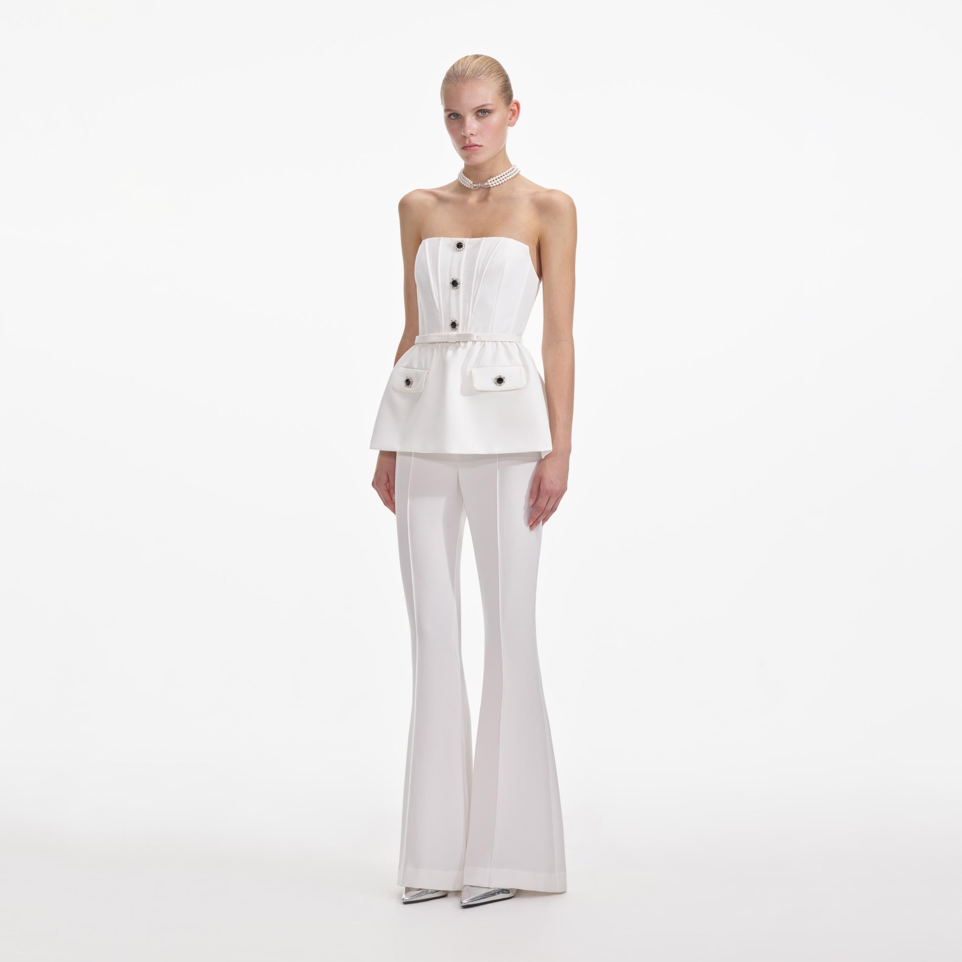 Side view of a woman wearing the White Strech Crepe Jumpsuit