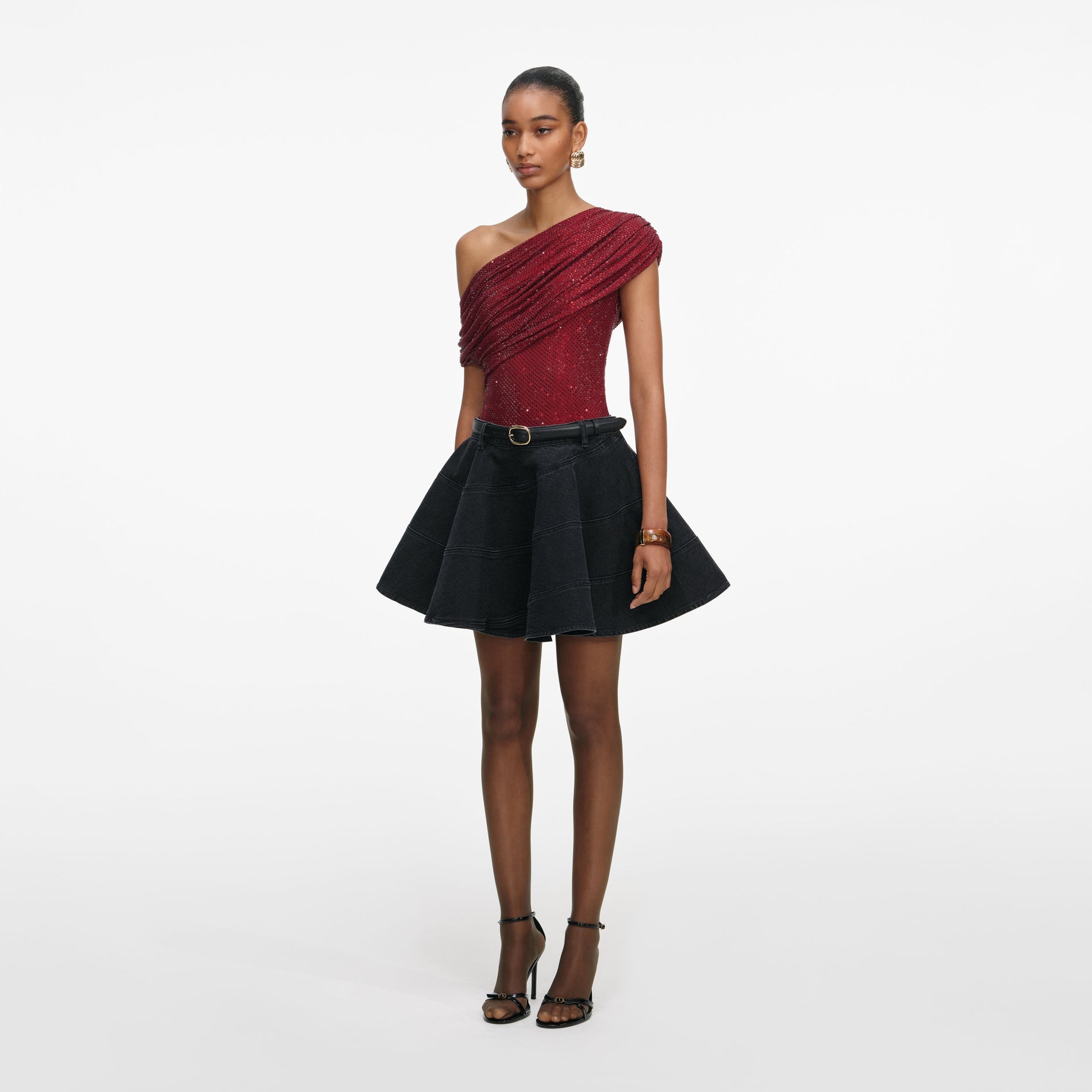 Side view of a woman wearing the Burgundy Rhinestone Drape Top