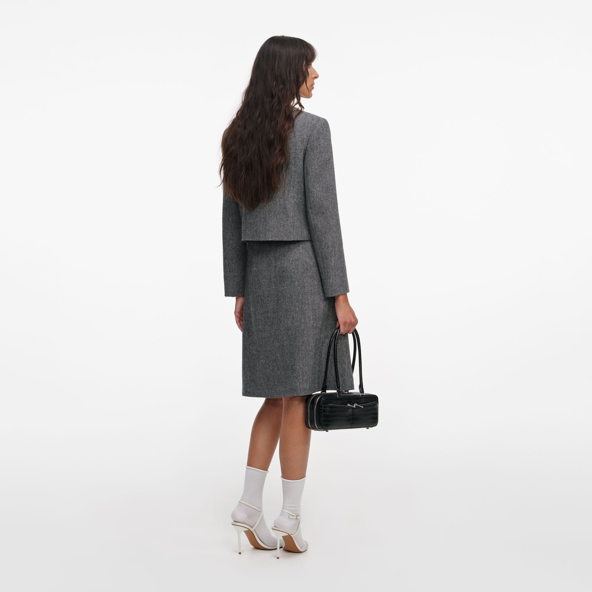 Back view of a woman wearing the Grey Herringbone Crystal Trim Jacket