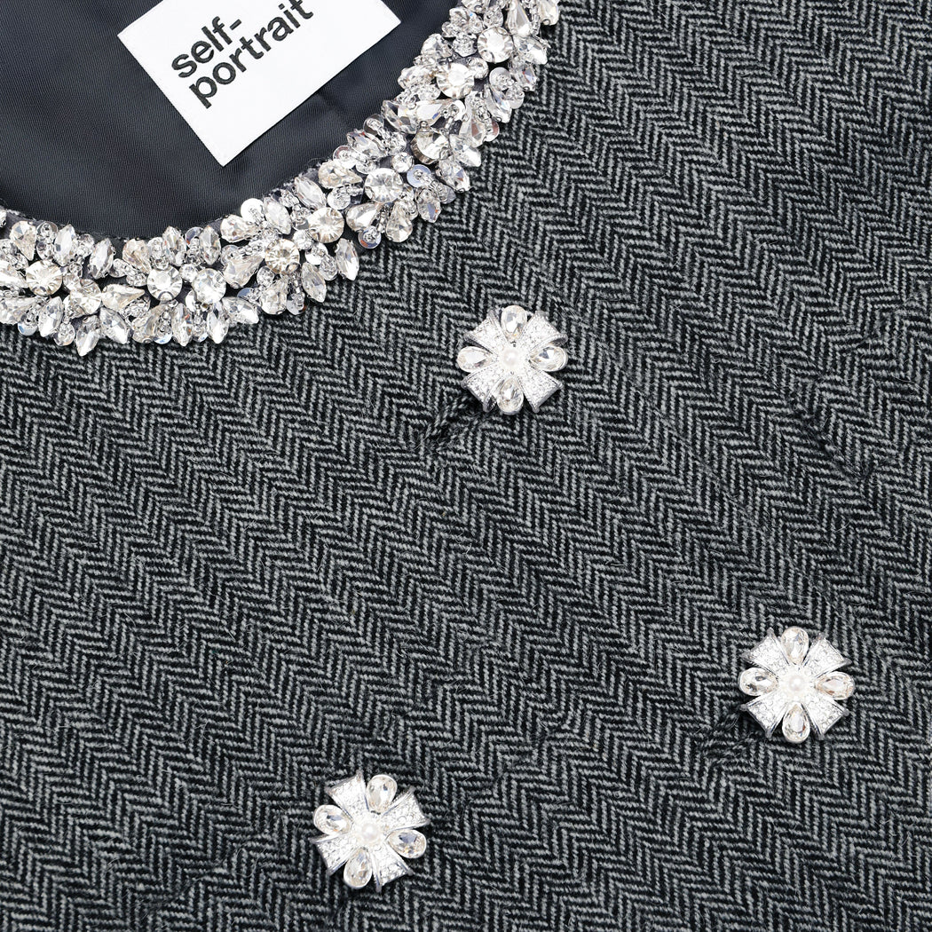 Side view of a woman wearing the Grey Herringbone Crystal Trim Jacket