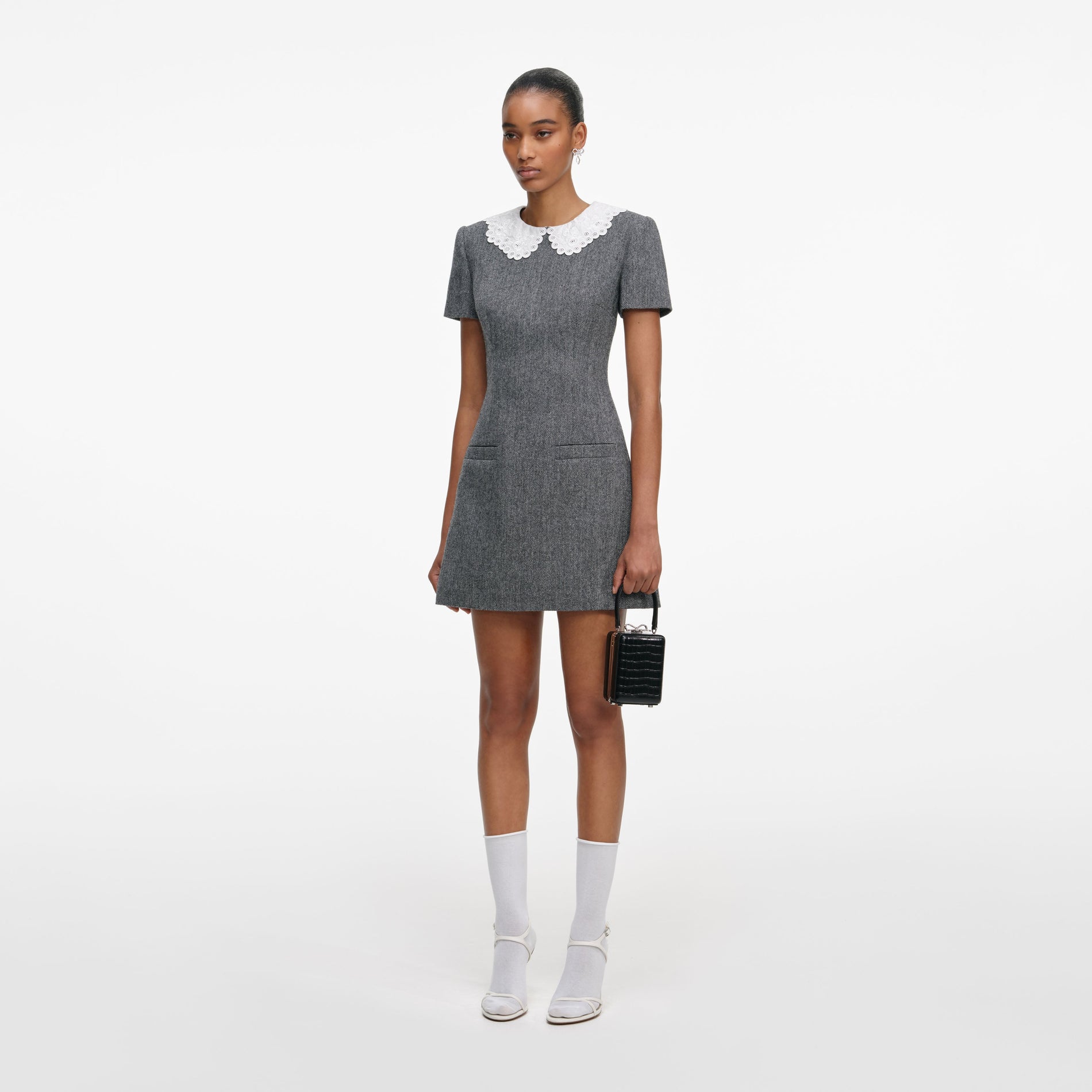 Side view of a woman wearing the Grey Herringbone Collared Mini Dress