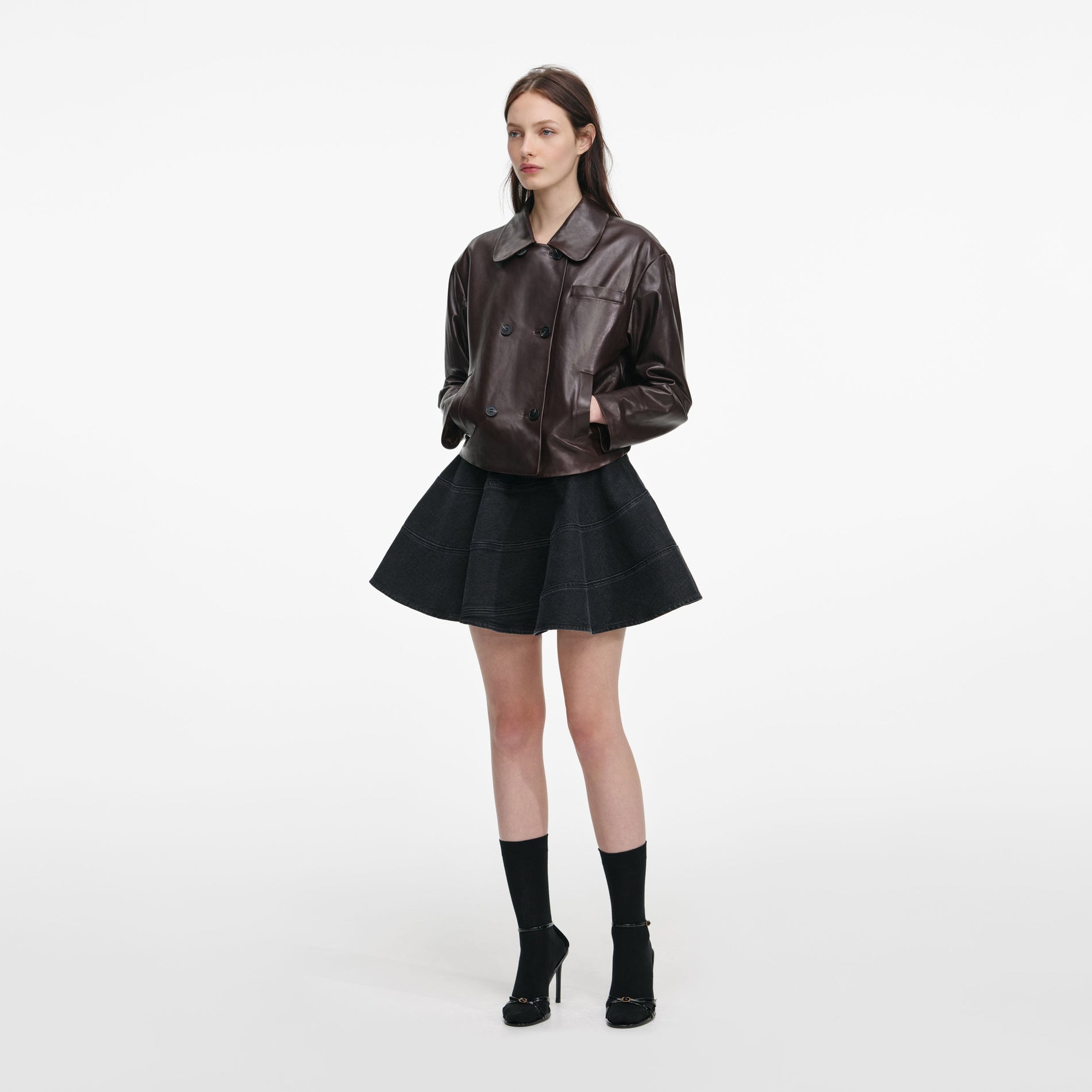 Side view of a woman wearing the Brown Cropped Leather Jacket