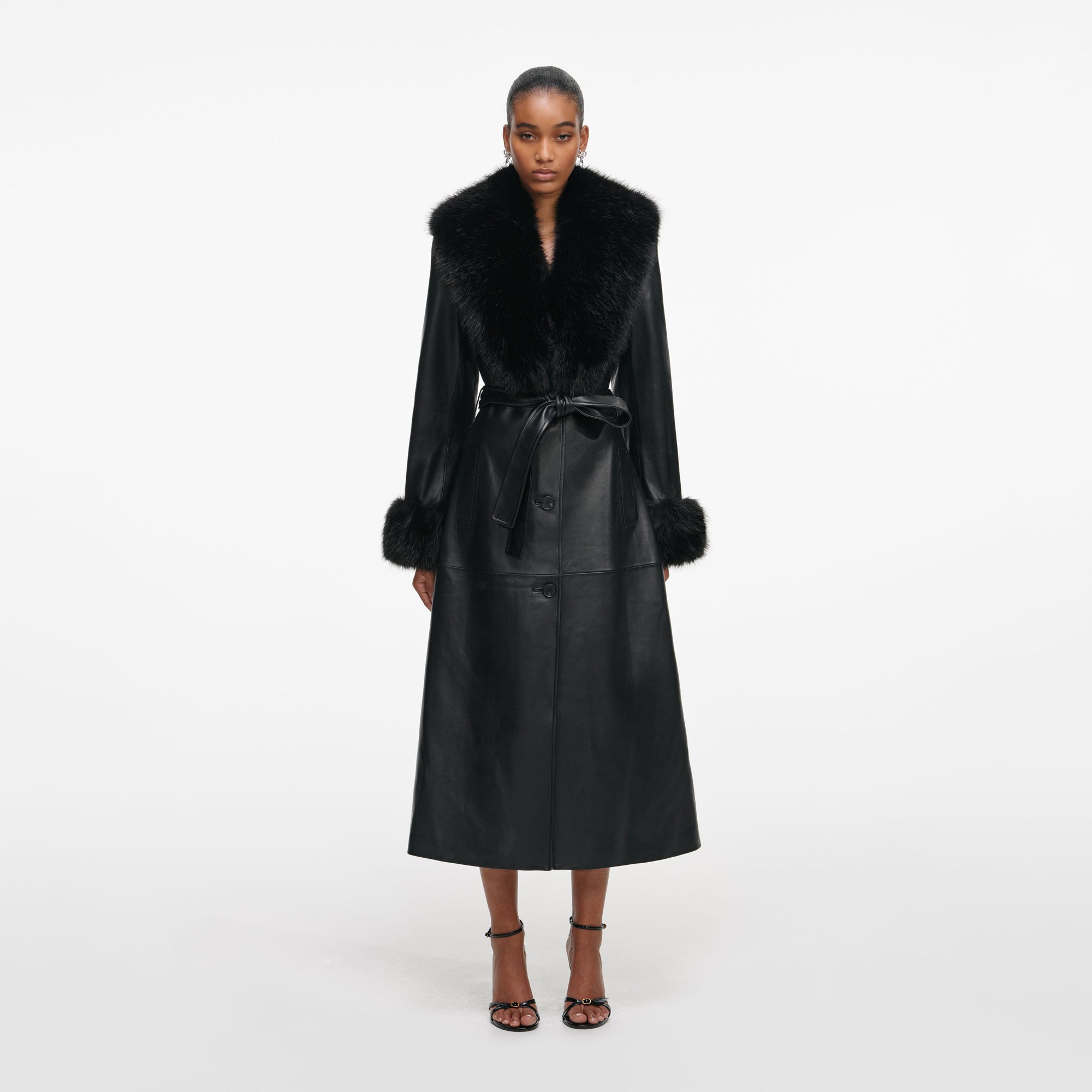 Front view of a woman wearing the Black Leather Faux Fur Collared Coat