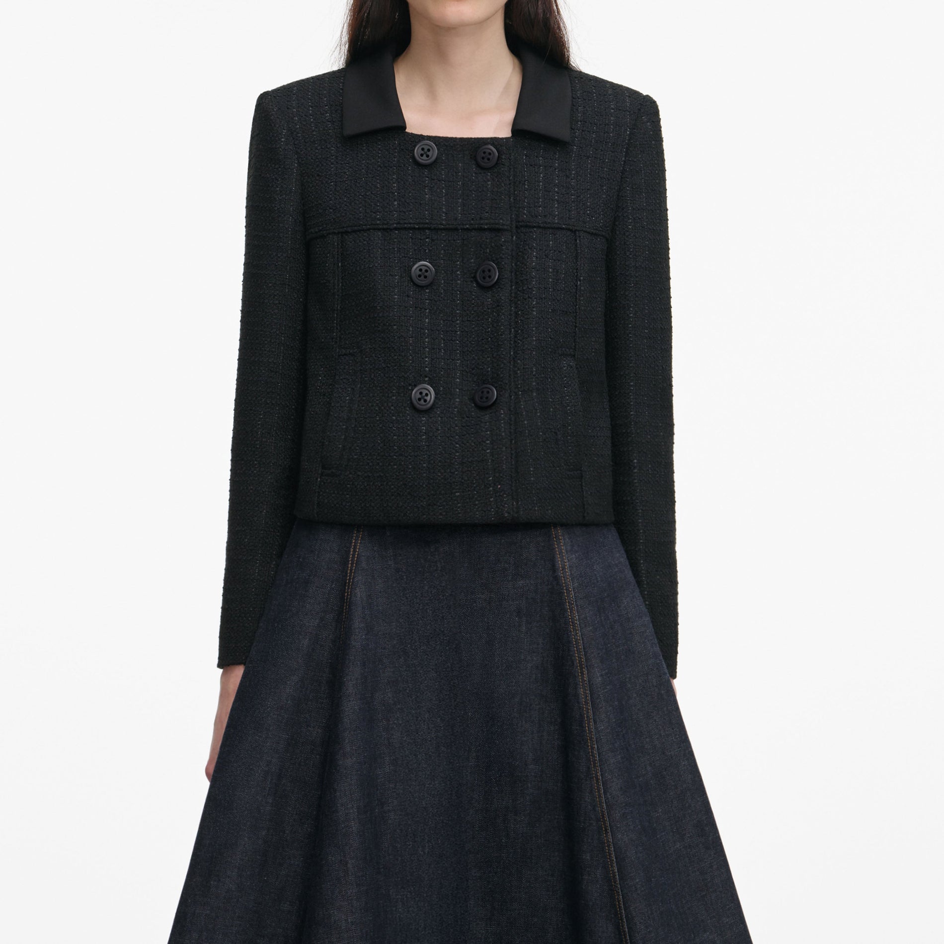 A close up of a woman wearing the Black Boucle Cropped Jacket