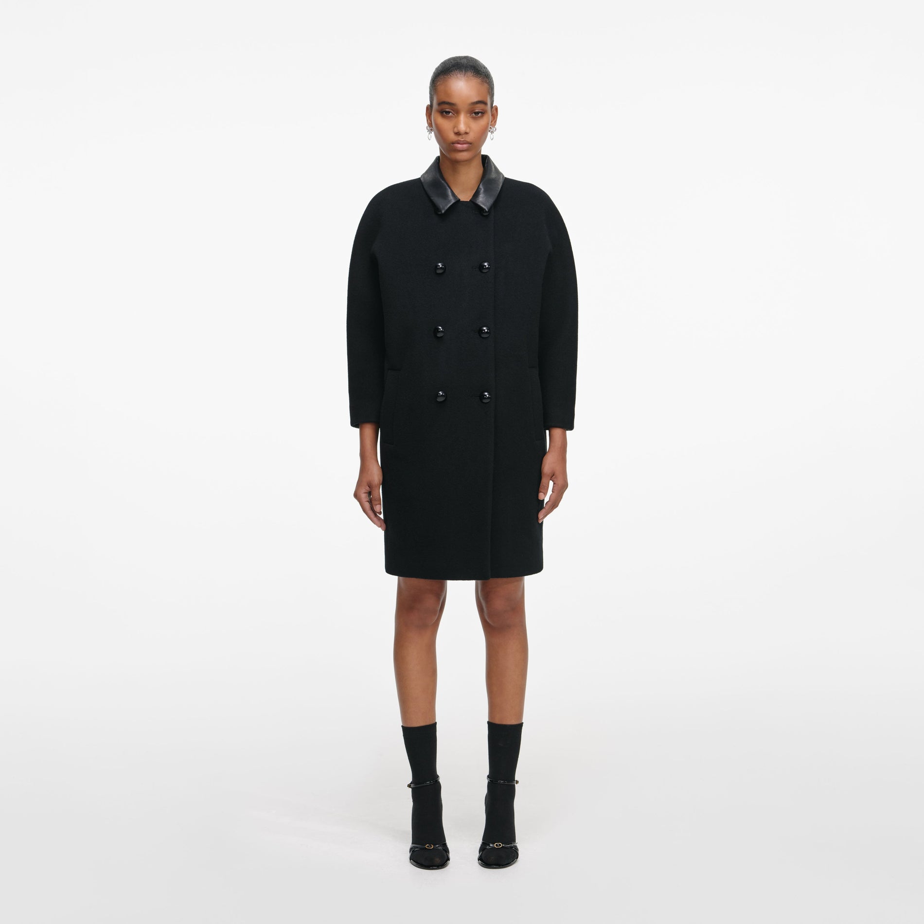 Front view of a woman wearing the Black Double Breasted Coat