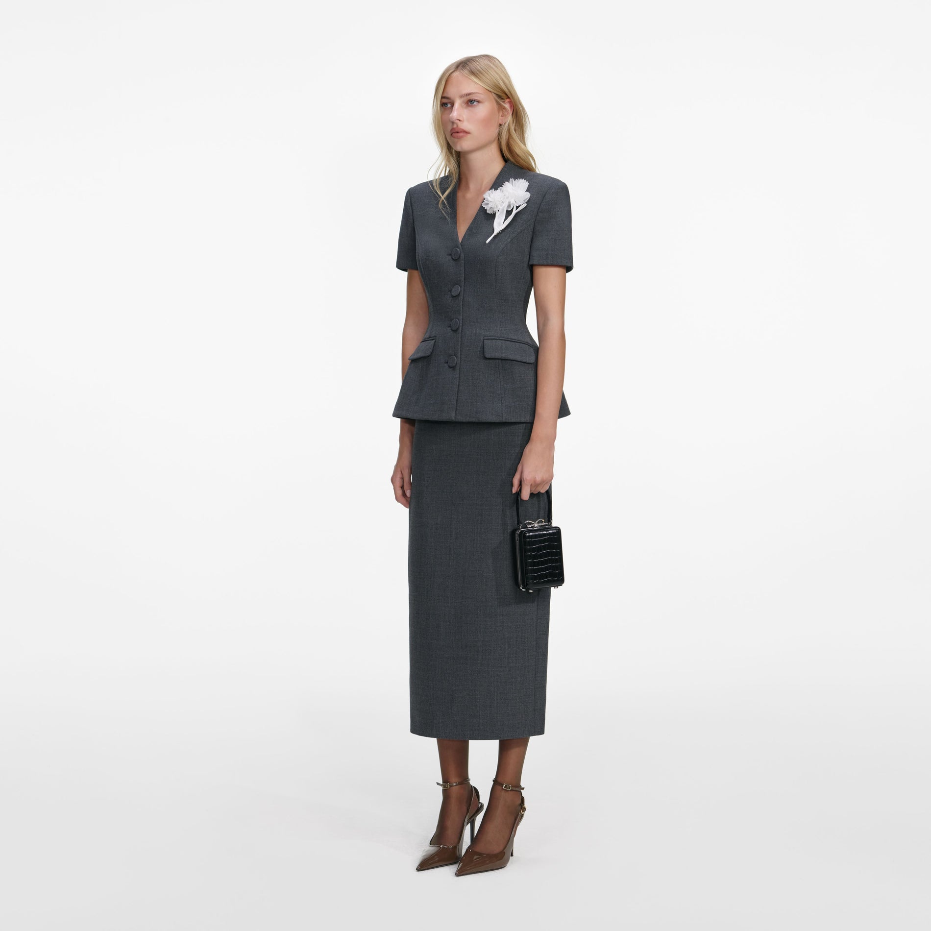 Side view of a woman wearing the Grey Tailored Flower Detail Midi Dress