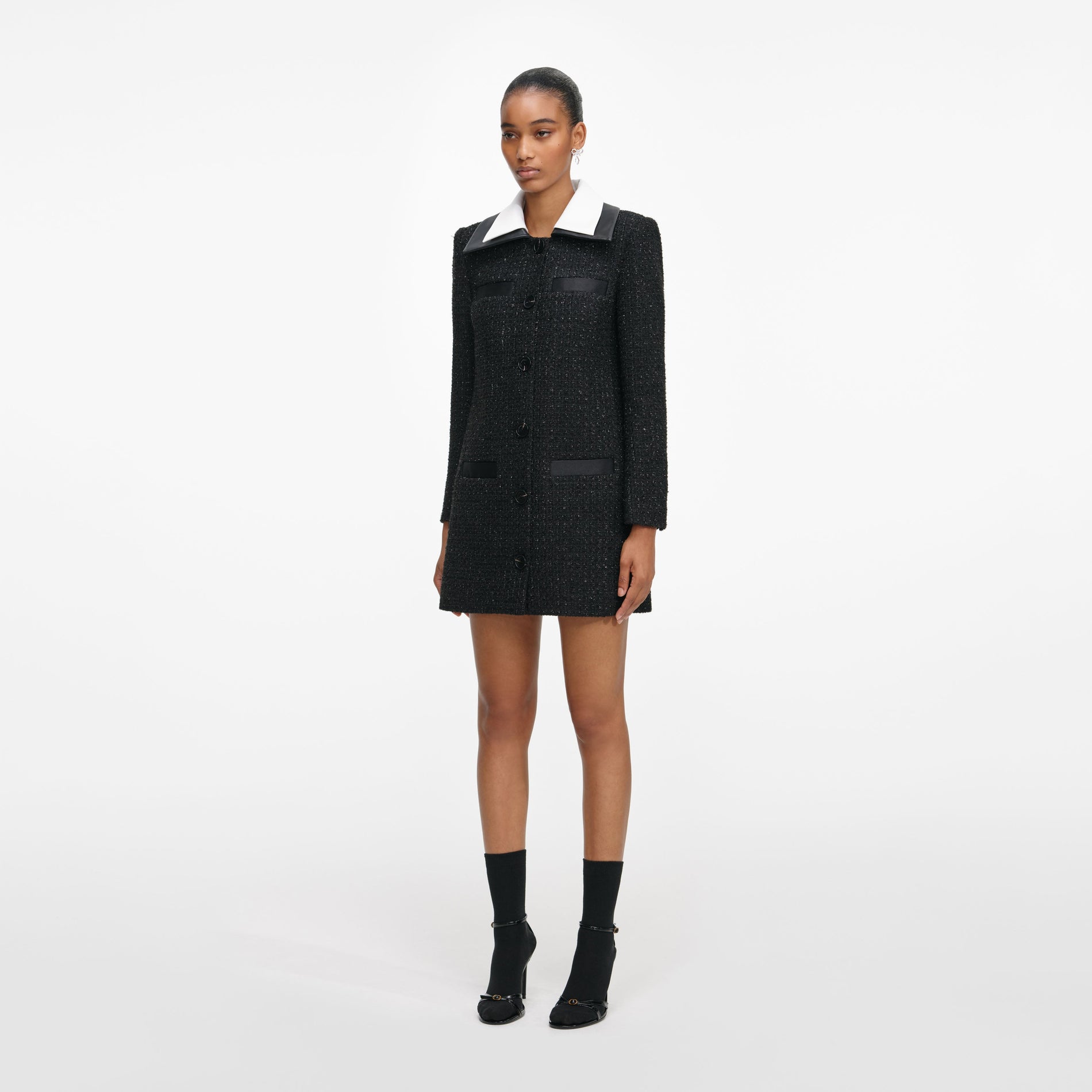 Side view of a woman wearing the Black Boucle Contrast Collar Mini Dress
