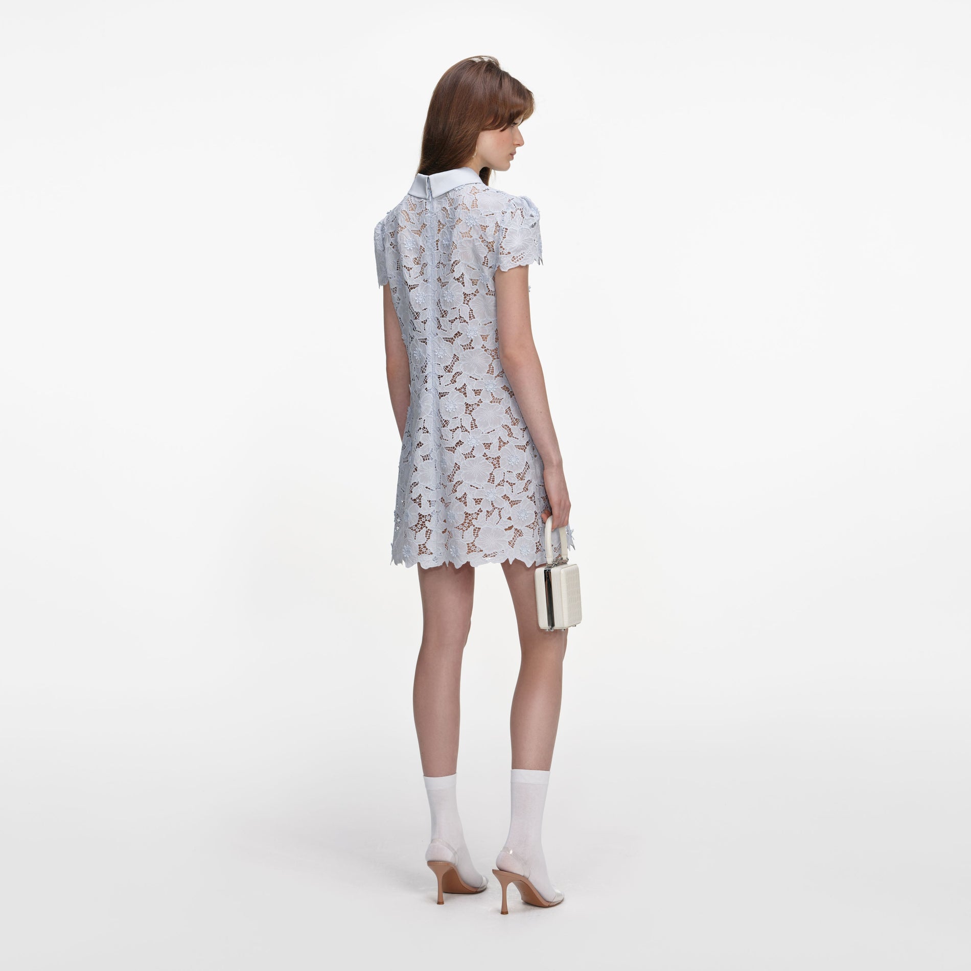 Back view of a woman wearing the Blue Guipure Lace Mini Dress