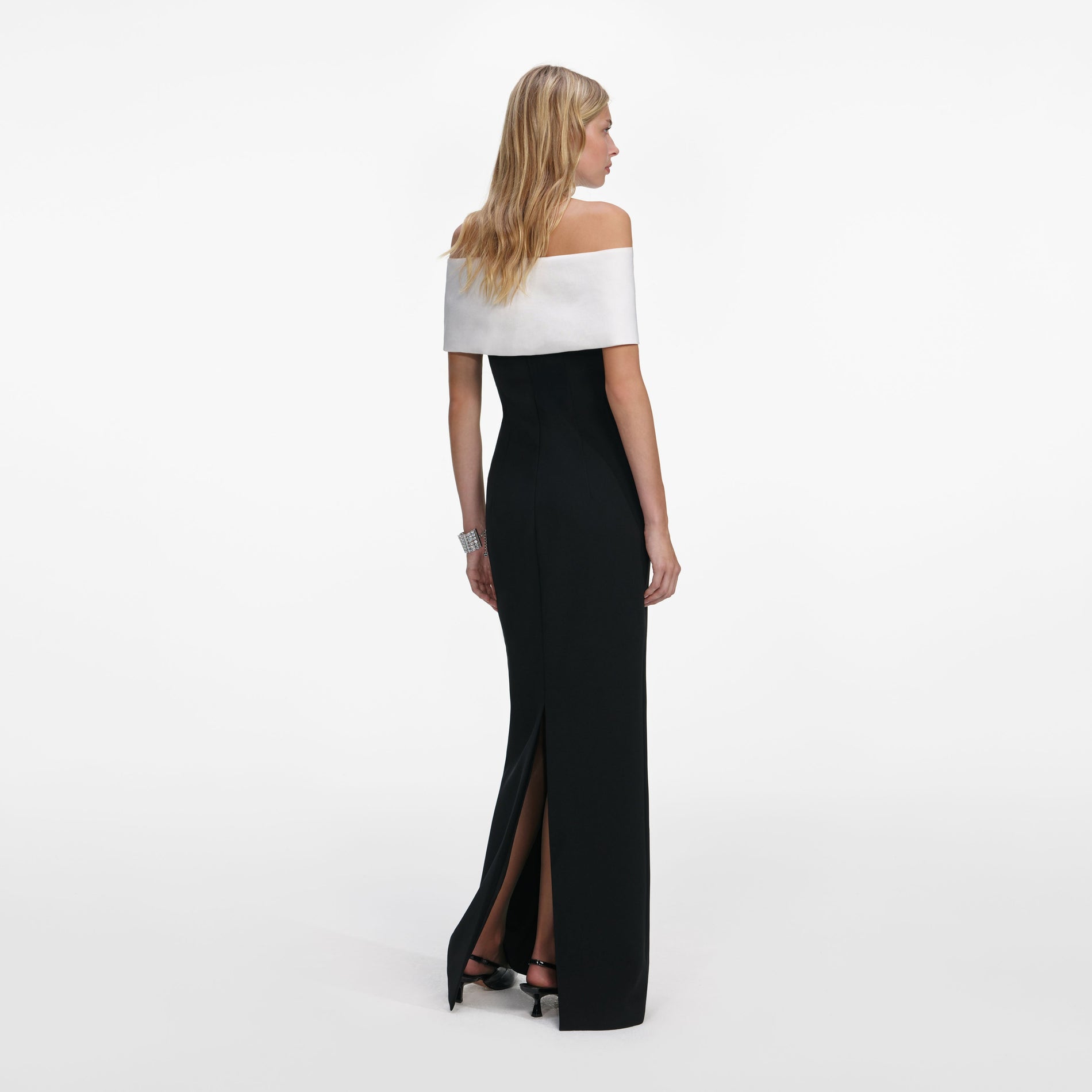 Back view of a woman wearing the Black Crepe Flower Maxi Dress