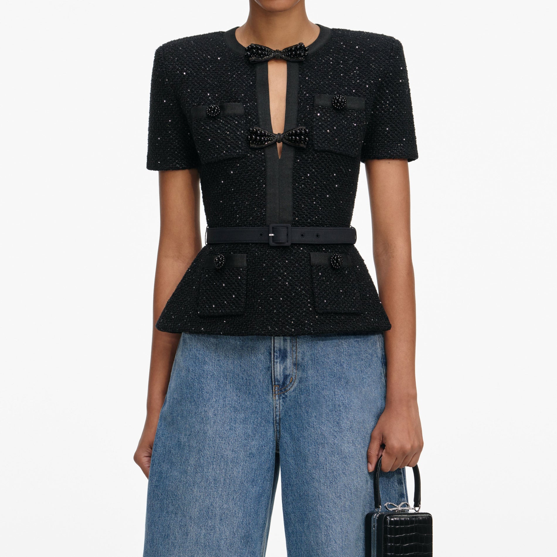 A close up of a woman wearing the Black Sequin Knit Top