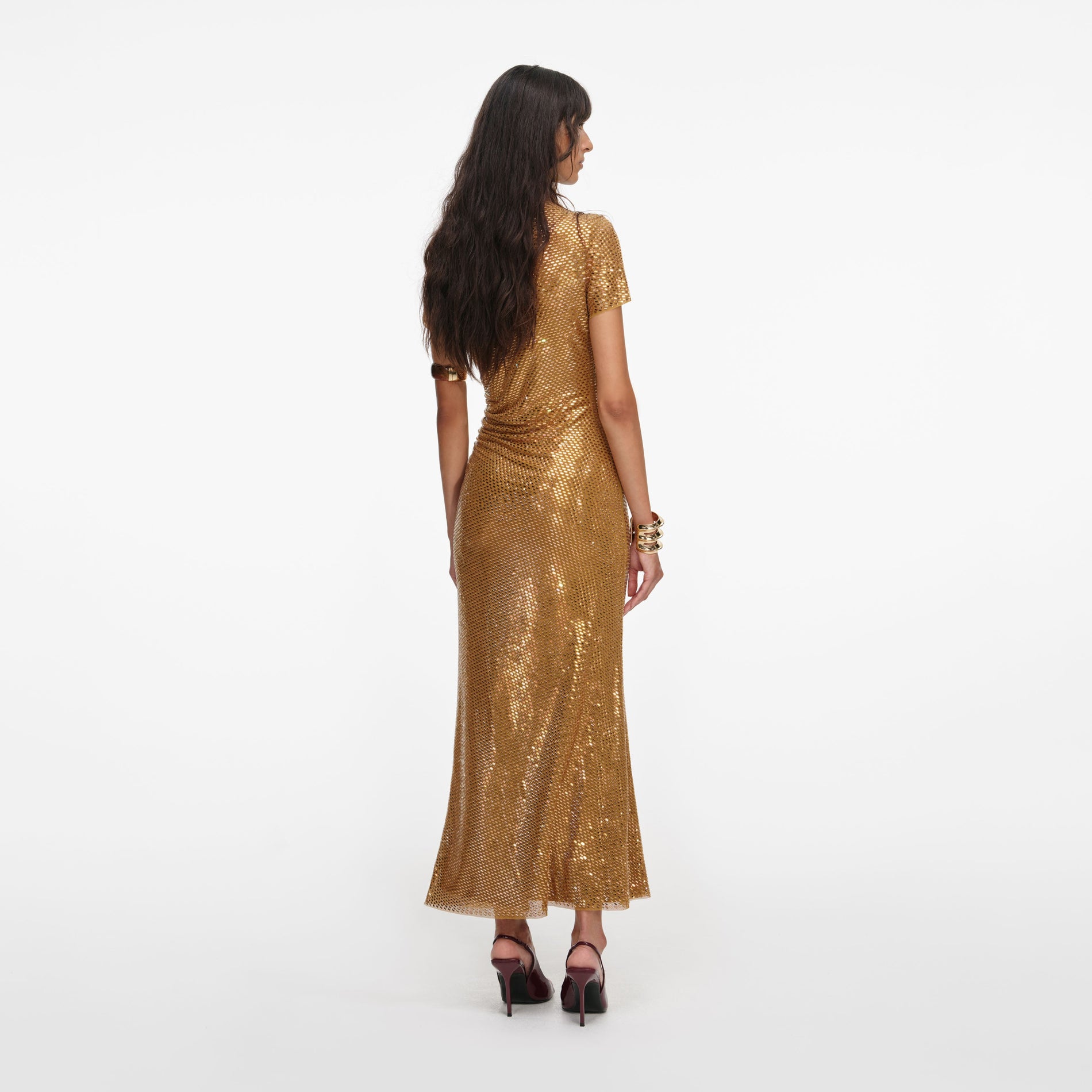 Back view of a woman wearing the Gold Rhinestone Drape Midi Dress