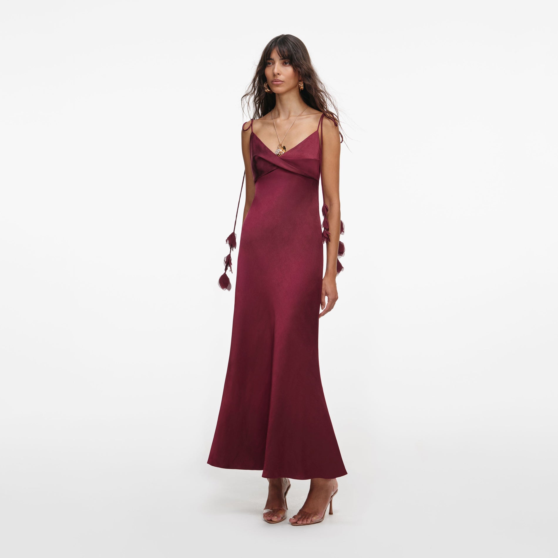 Side view of a woman wearing the Burgundy Satin Flower Midi Dress