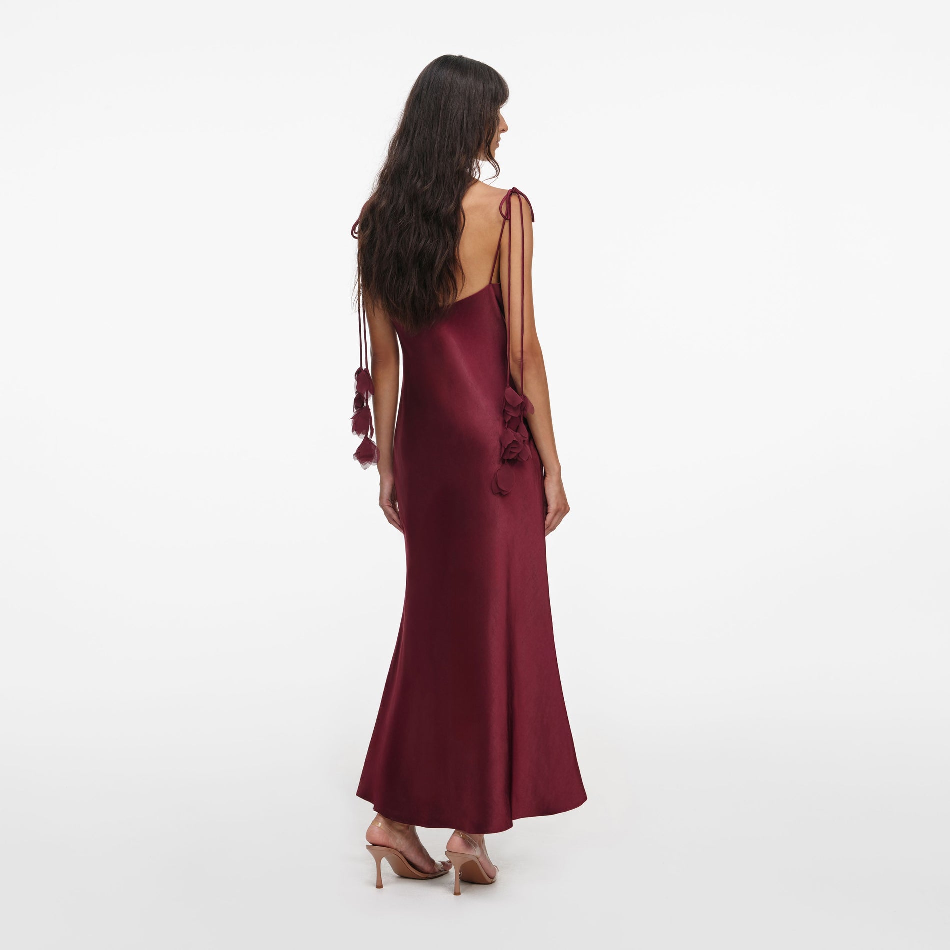 Back view of a woman wearing the Burgundy Satin Flower Midi Dress