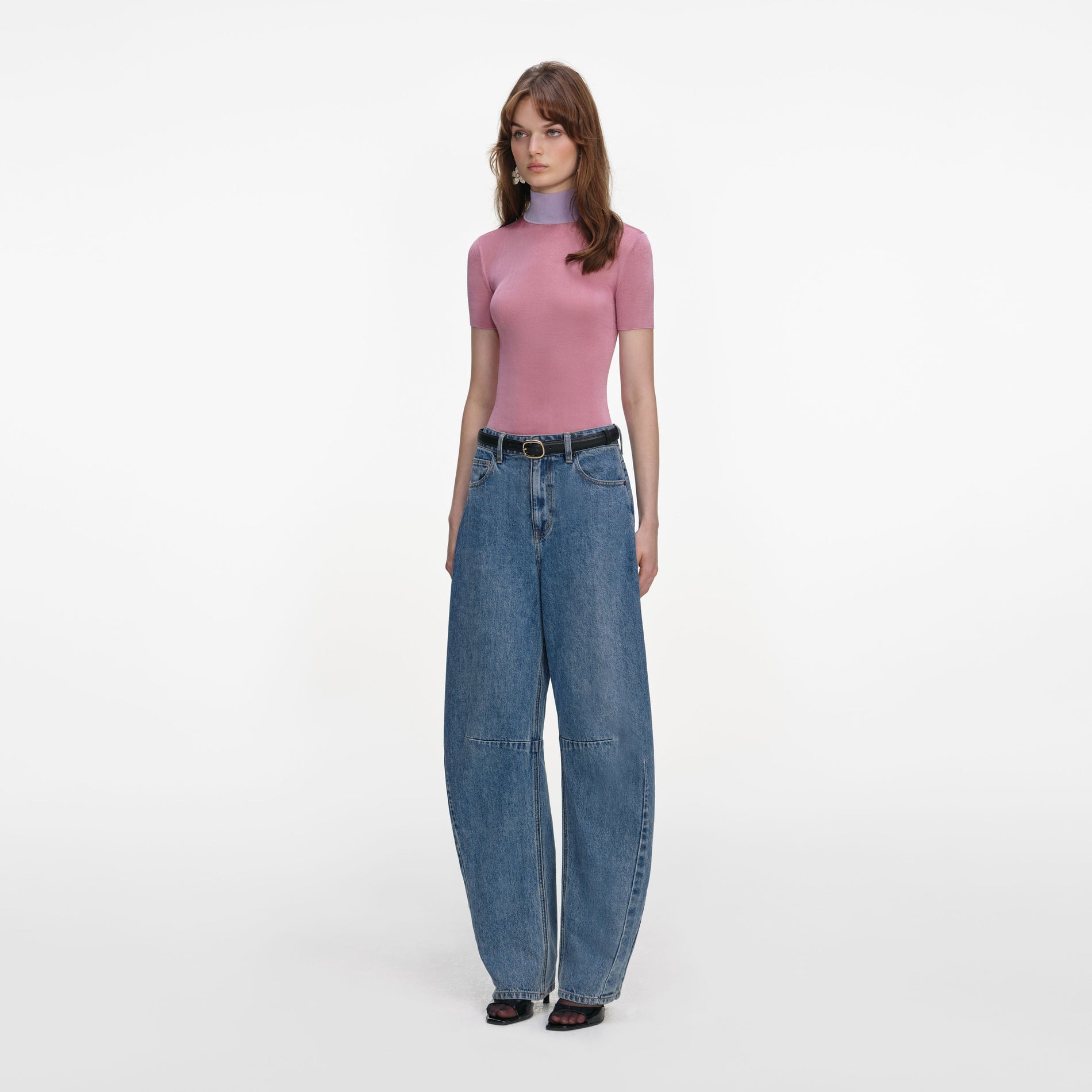 Side view of a woman wearing the Pink Short Sleeve Viscose Knit Top