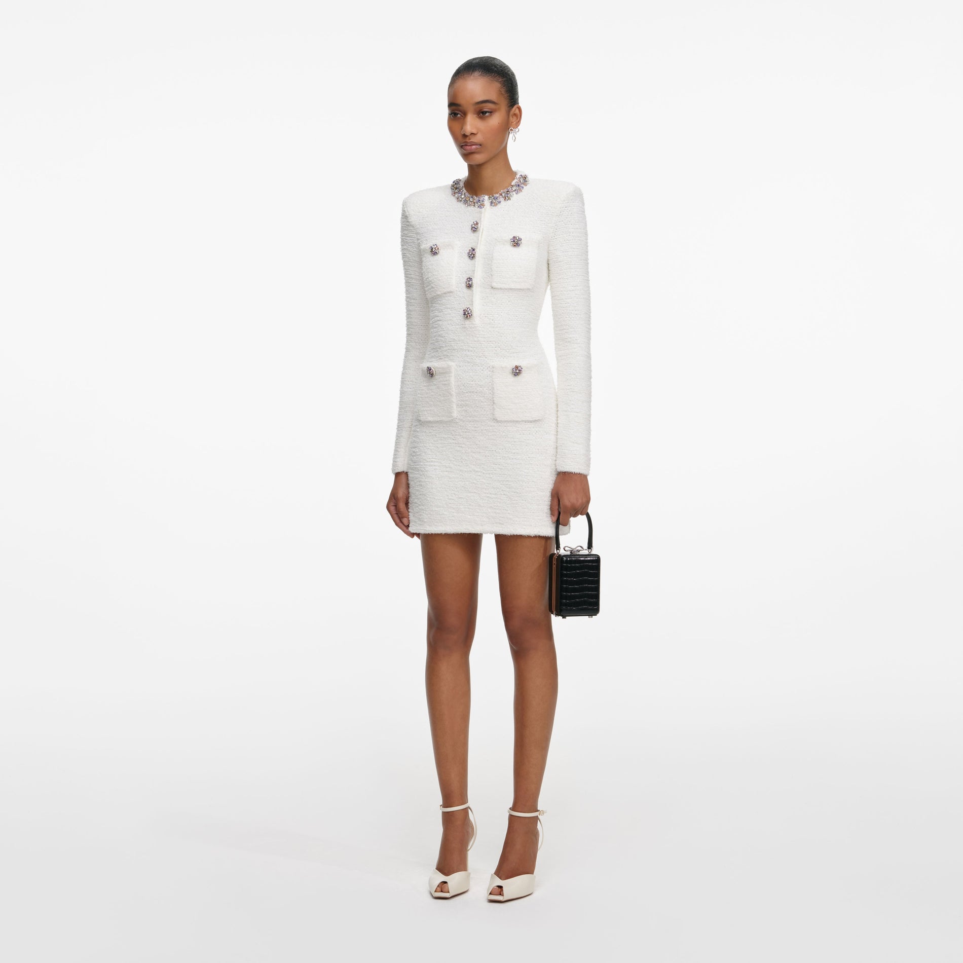 Side view of a woman wearing the Cream Crystal Trim Knit Mini Dress