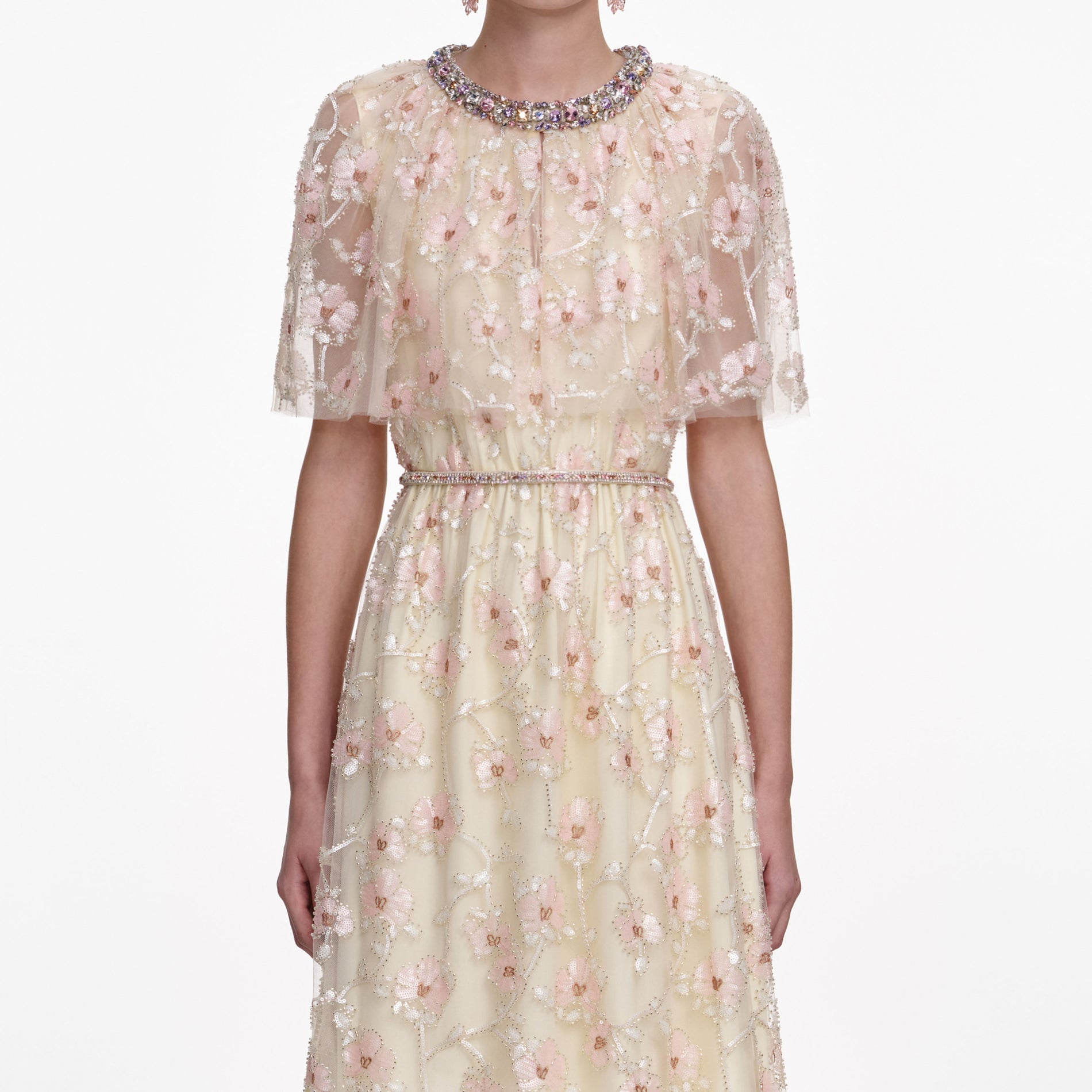 A close up of a woman wearing the Champagne Floral Embellished Maxi Dress