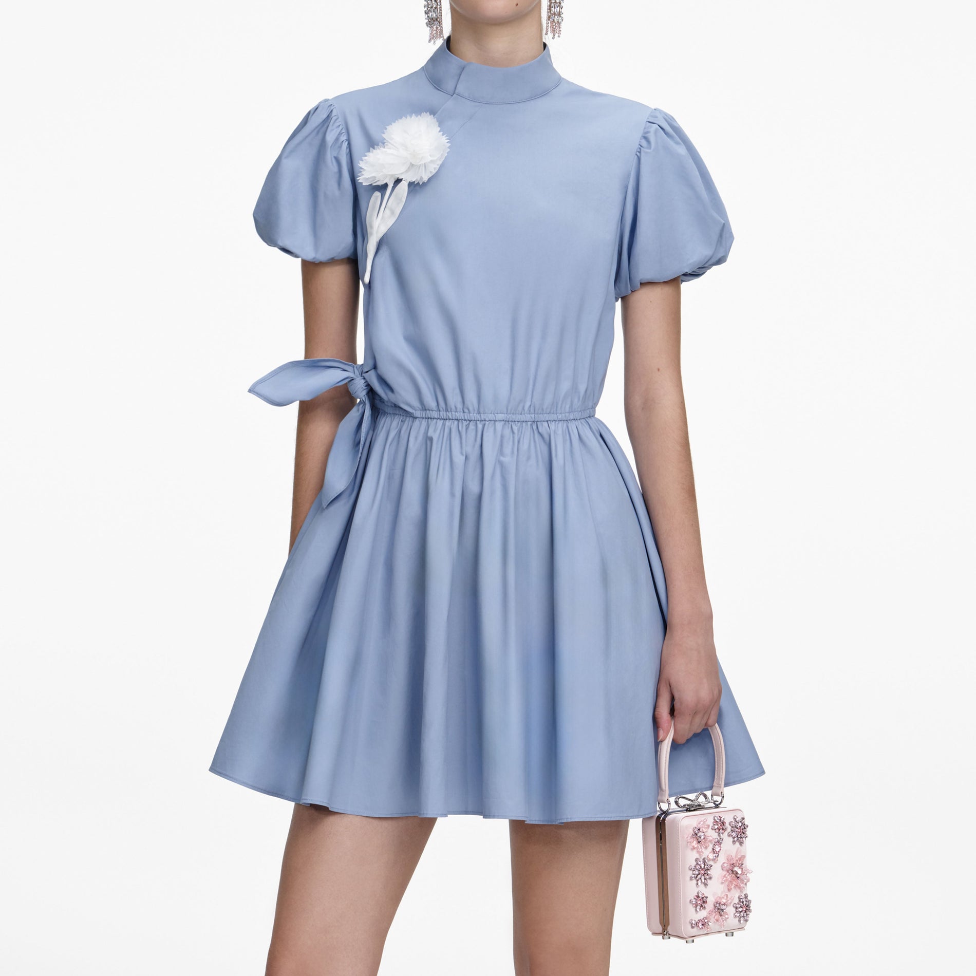 A close up of a woman wearing the Blue Cotton Drape Mini Dress