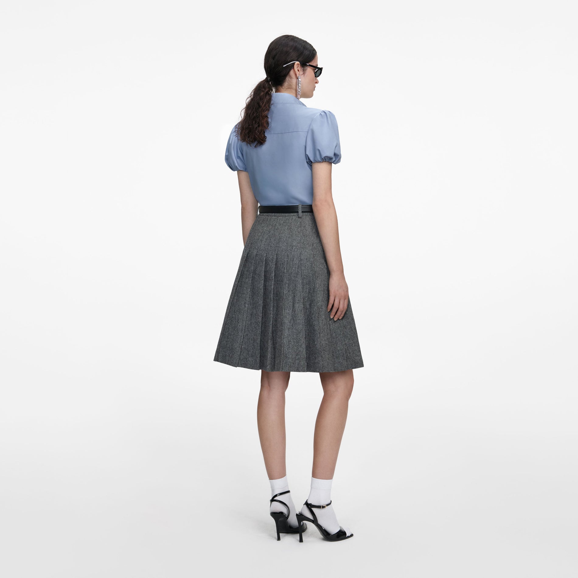 Back view of a woman wearing the Blue Cotton Tie Side Top