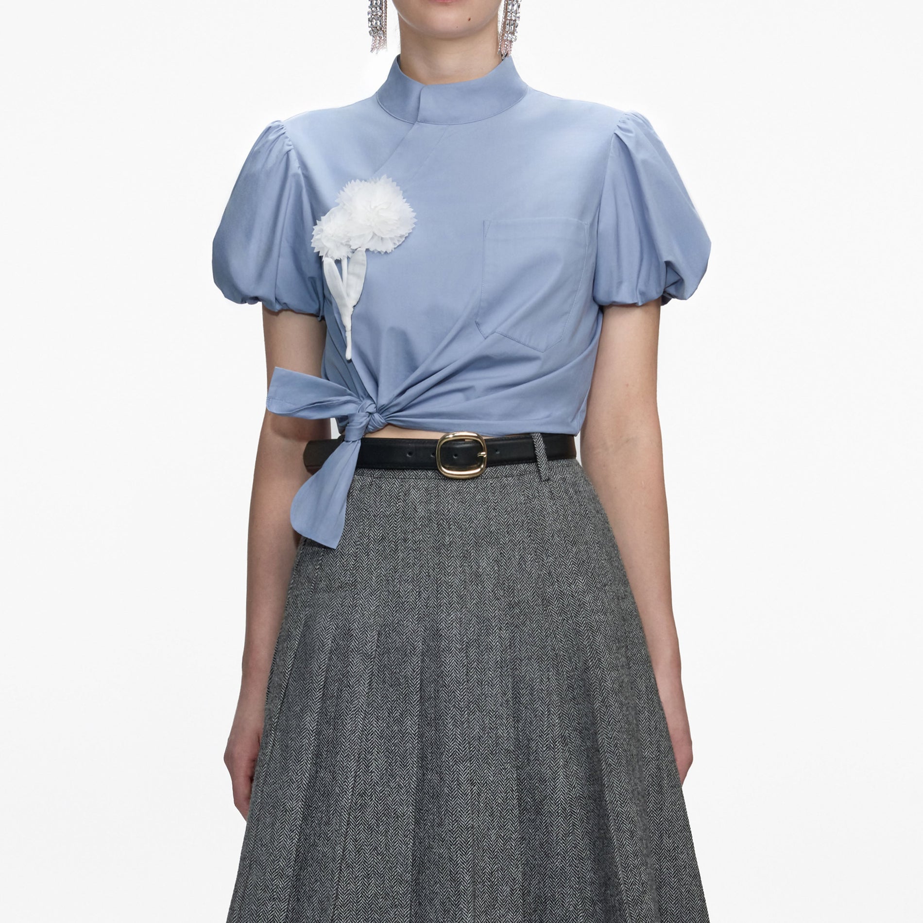 A close up of a woman wearing the Blue Cotton Tie Side Top